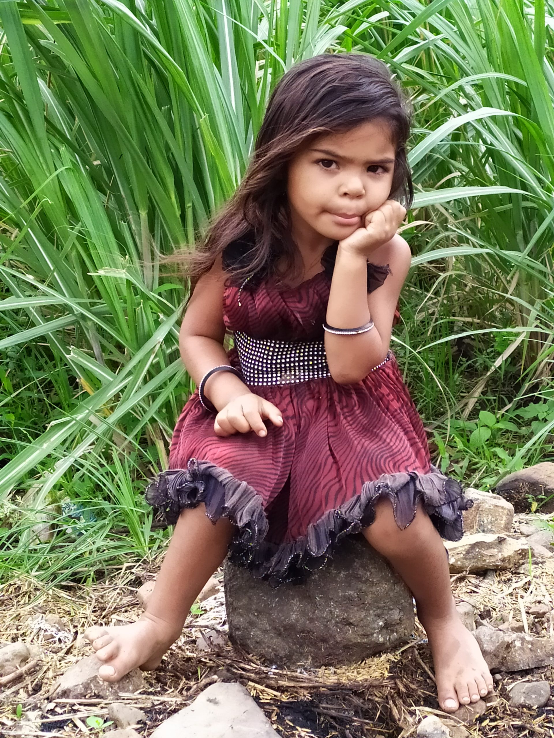 Girl Sitting on a rock in farm