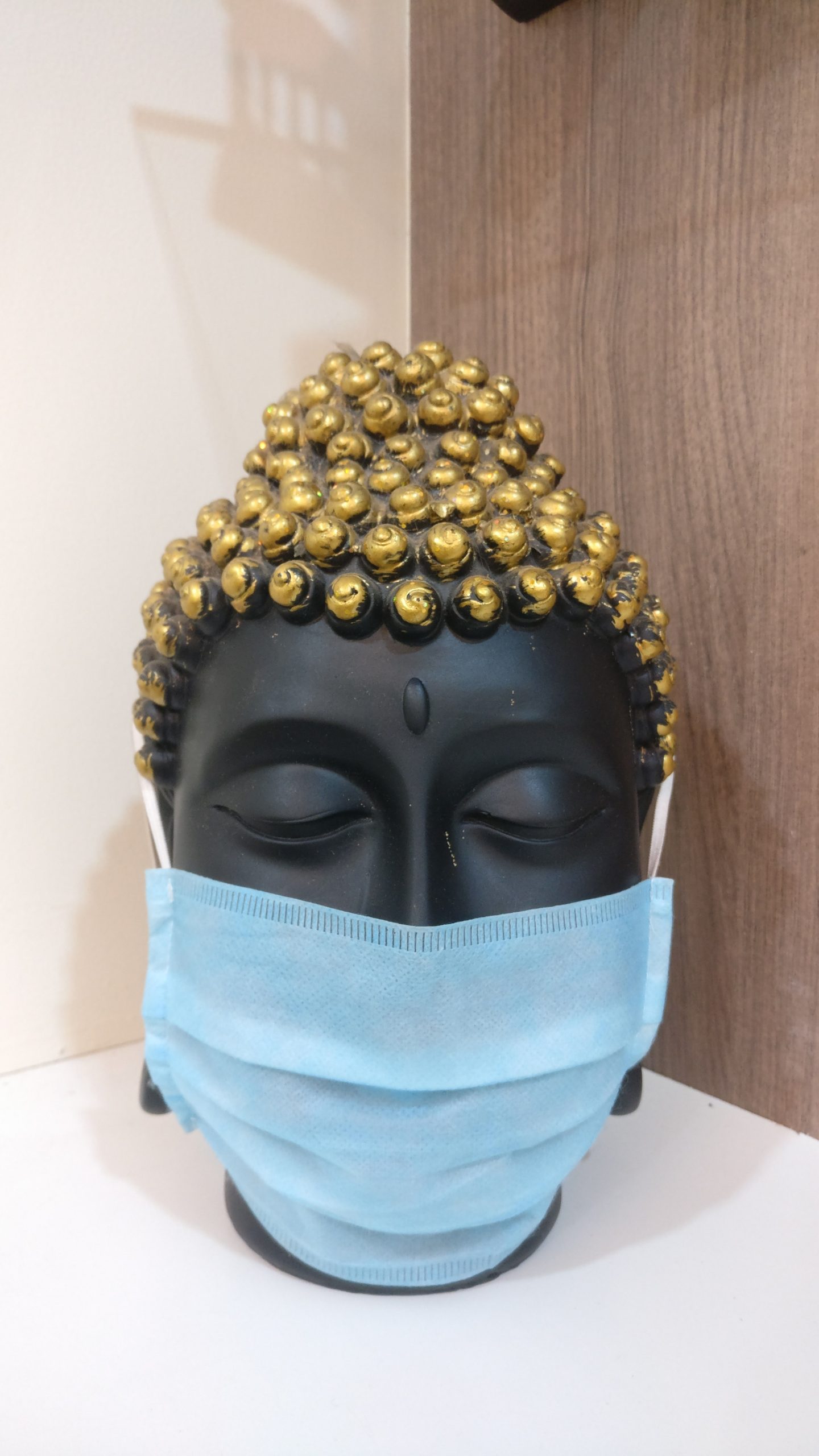 Buddha head statue with mask