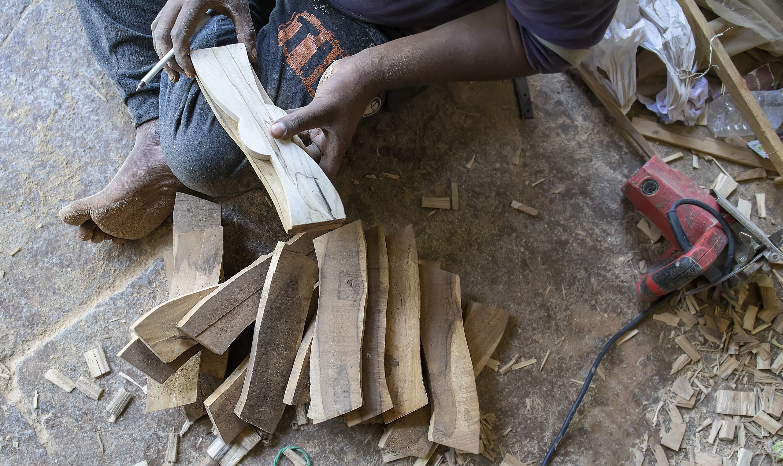 A carpenter working on wooden pieces