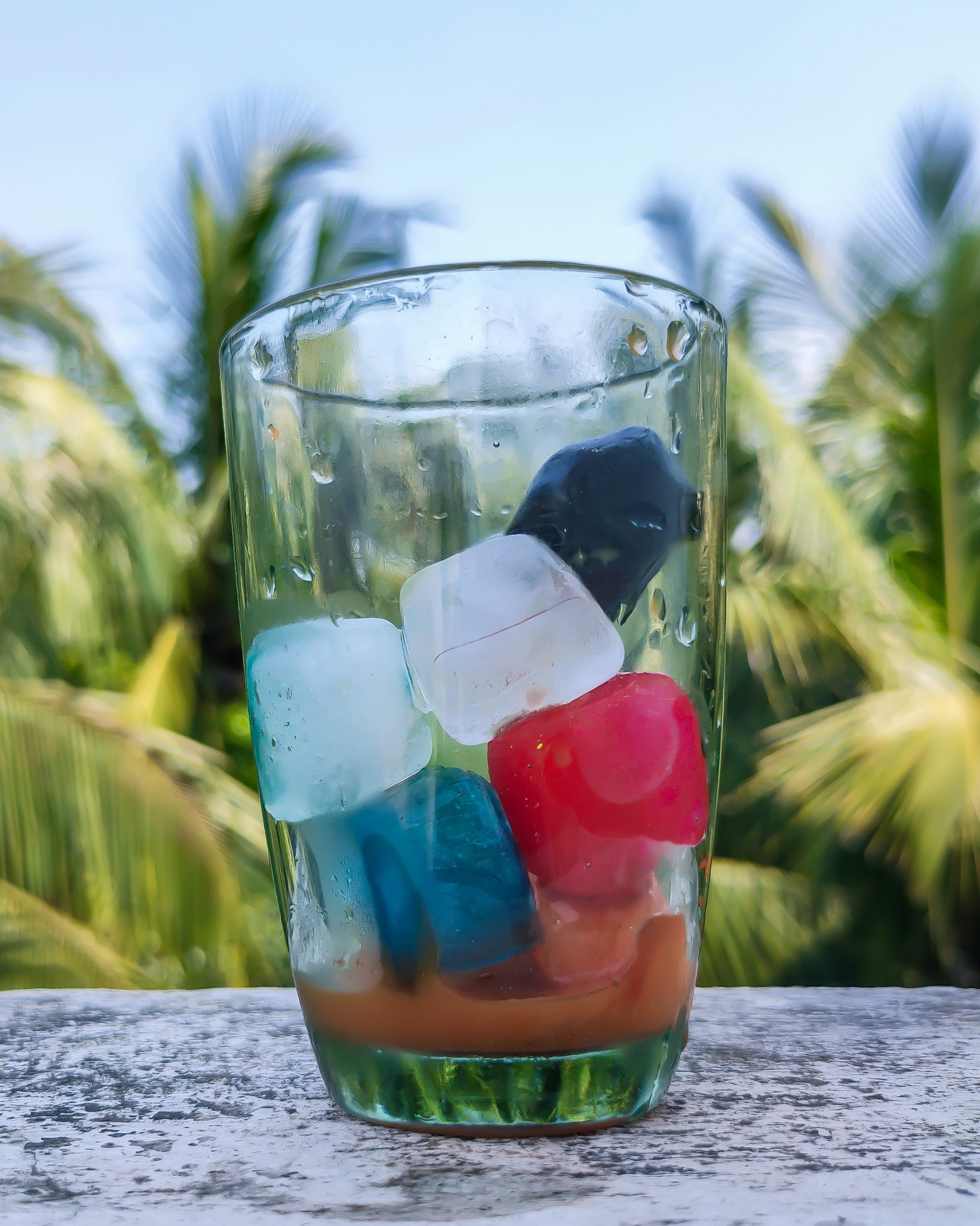 Colourful ice cubes in a glass