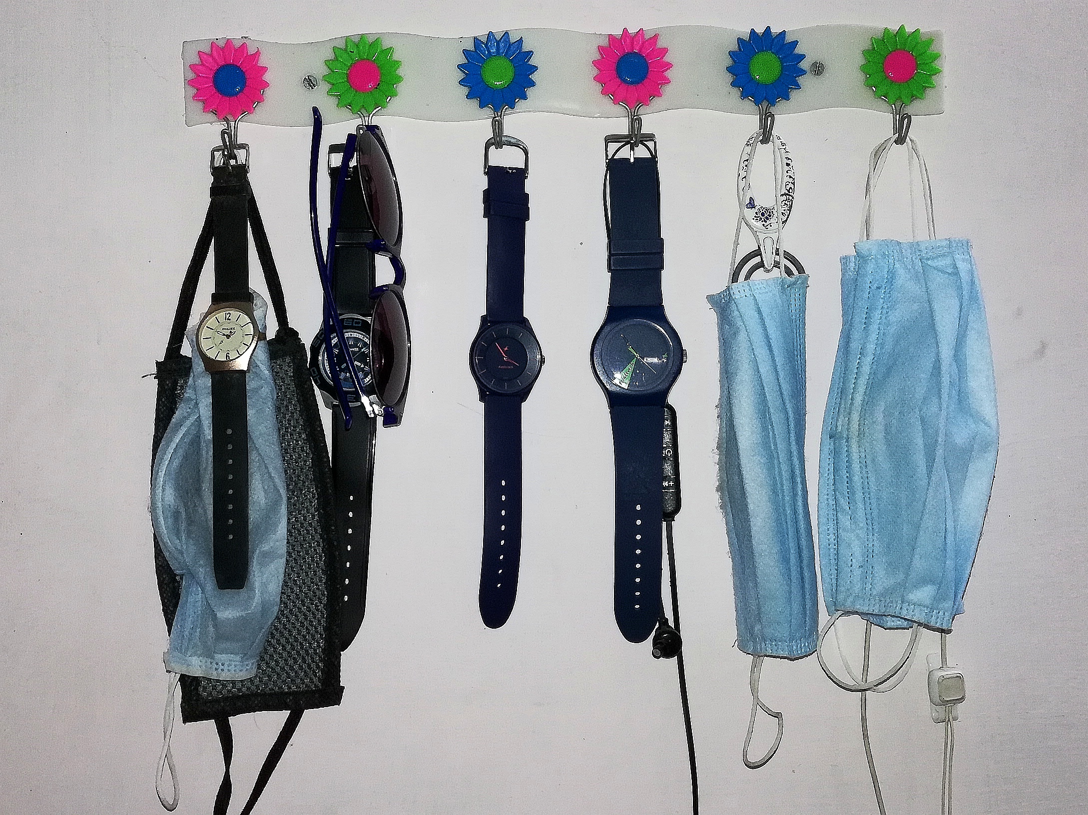 Watches and masks on hangers