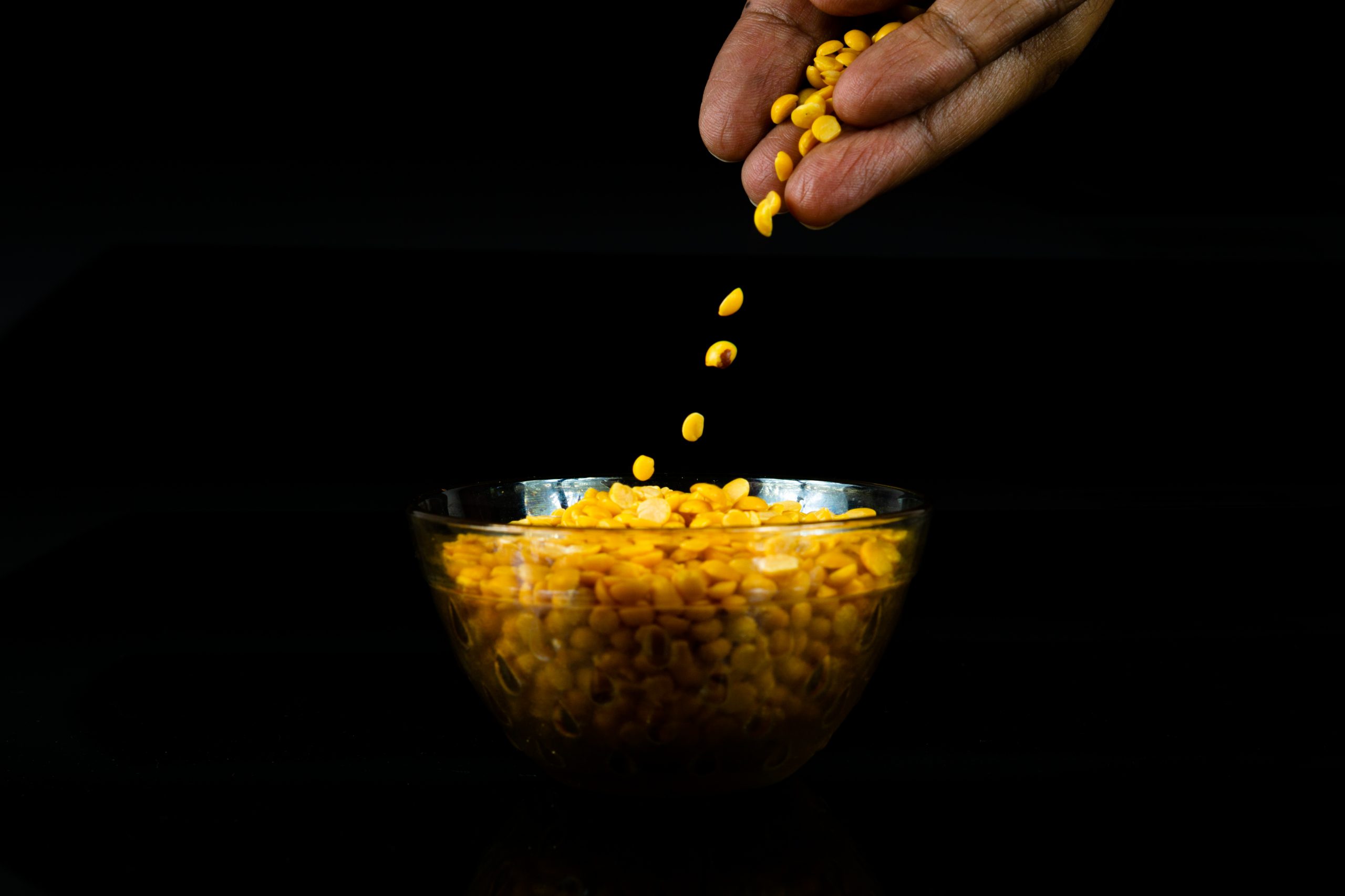 Putting split yellow gram in a bowl