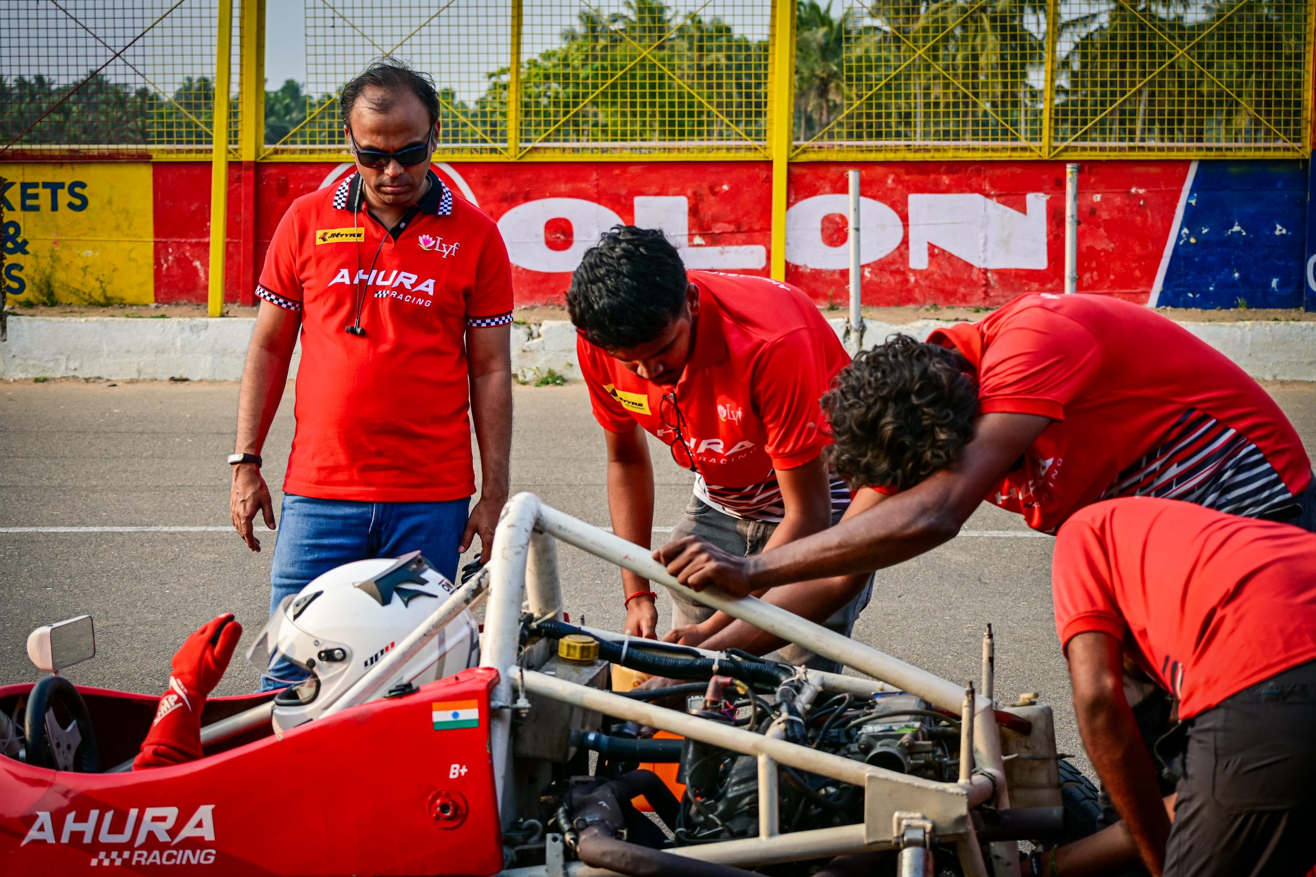 Mechanics repairing F1 racing car