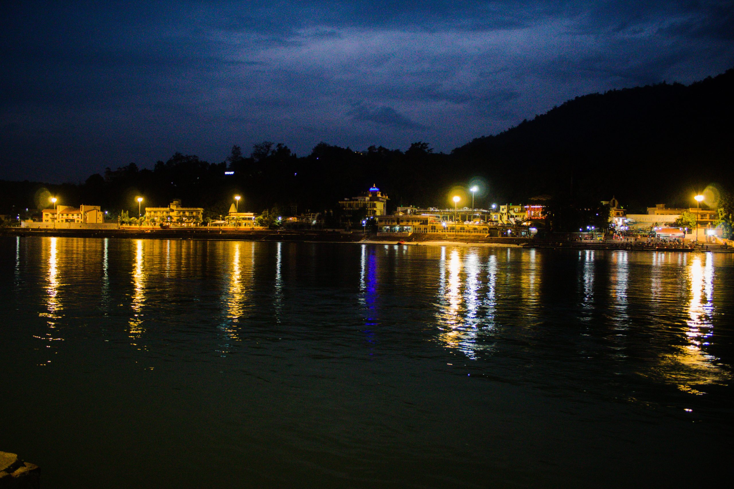 Night view of buildings near a lake