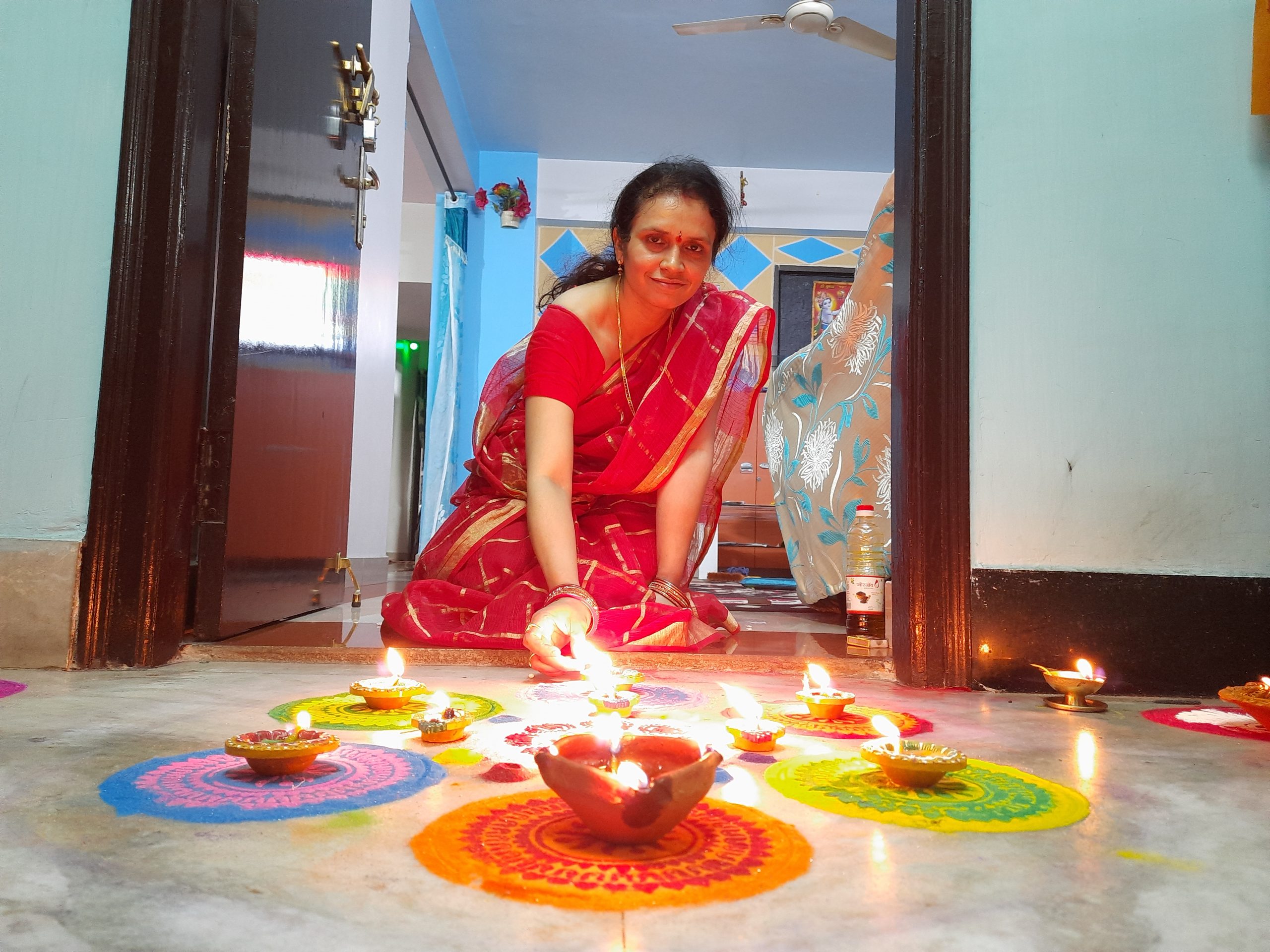 A woman with oil lamps and colorful design