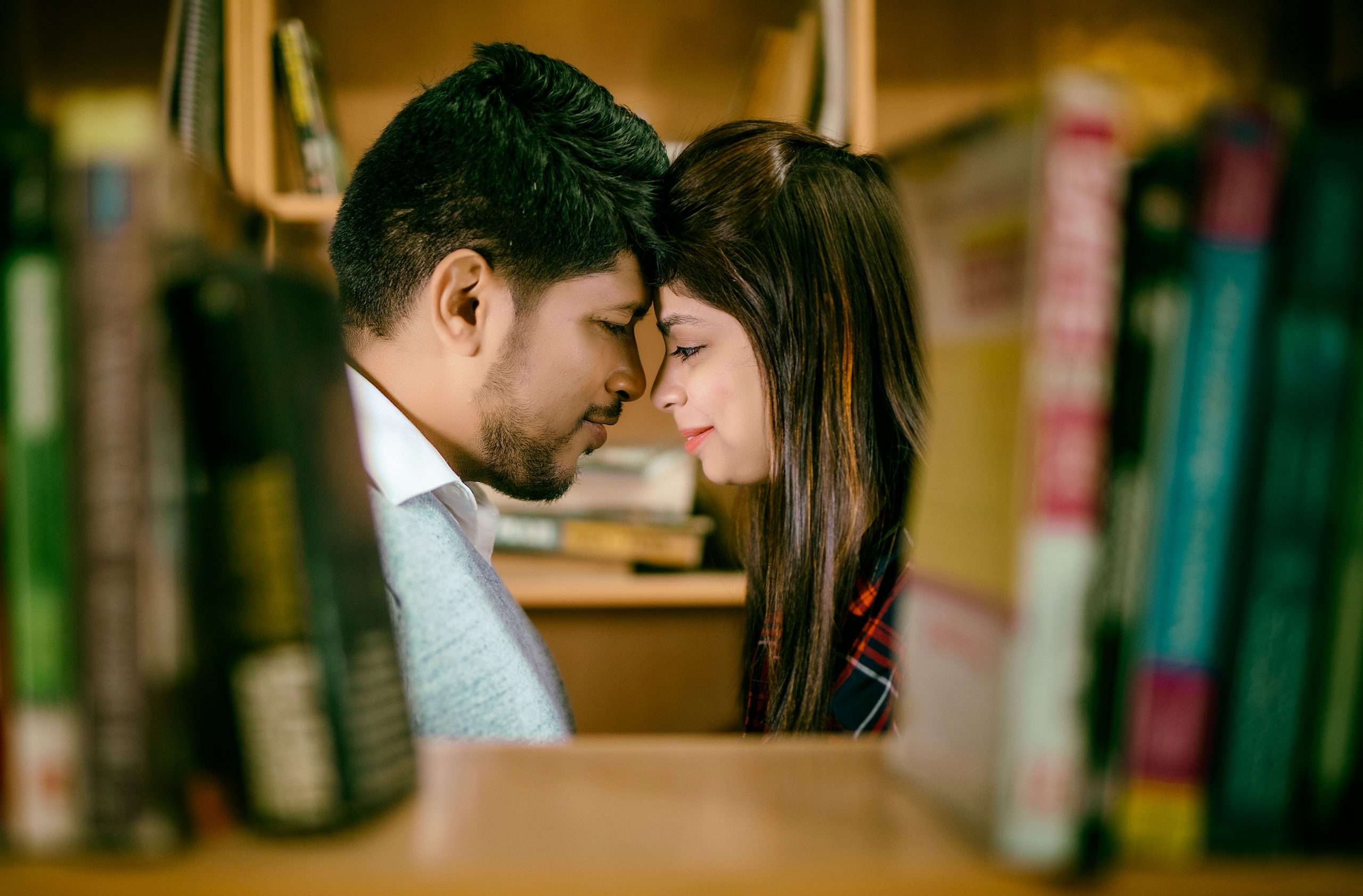 couple posing in library