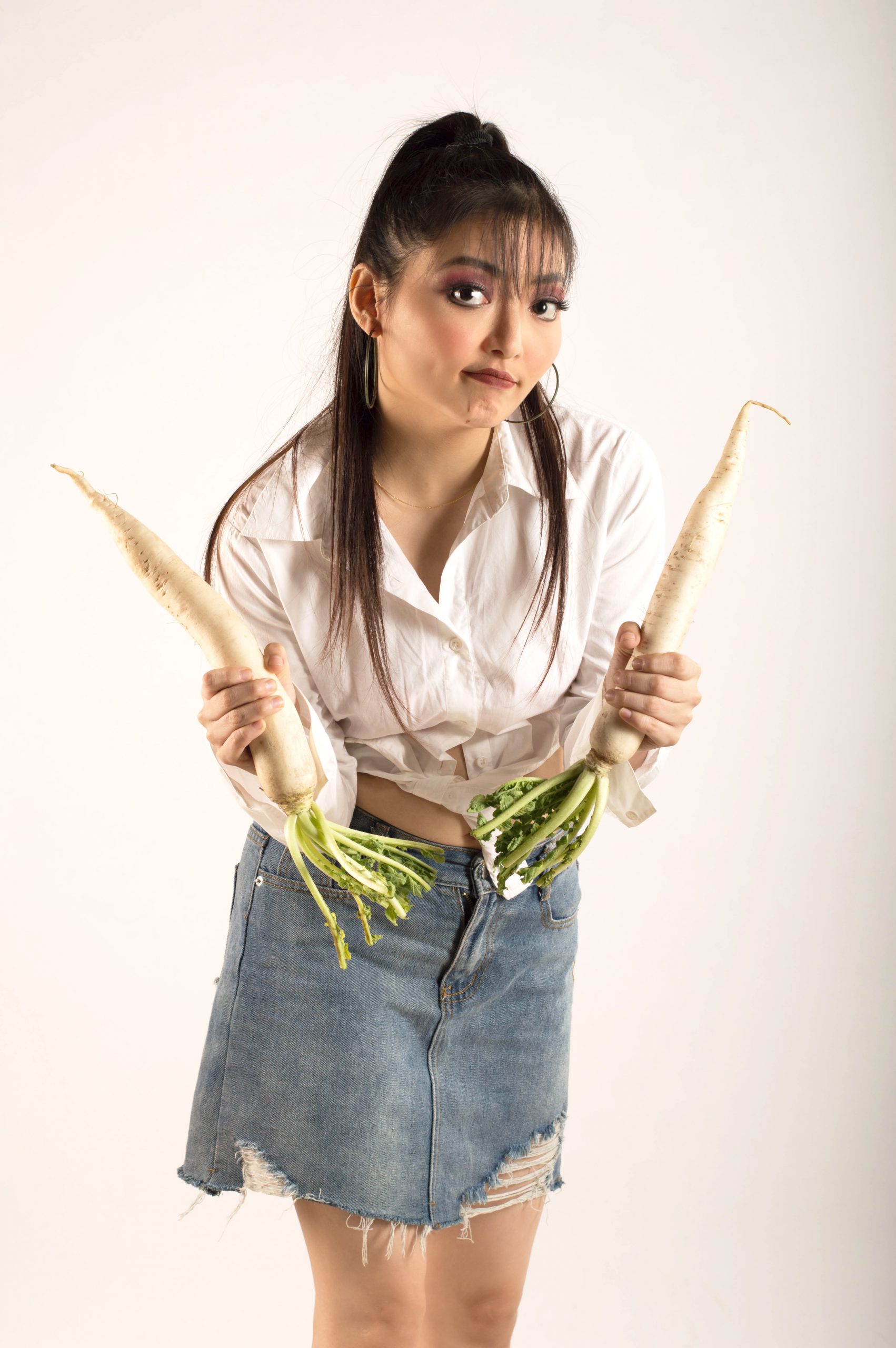girl showing raw fresh vegetables