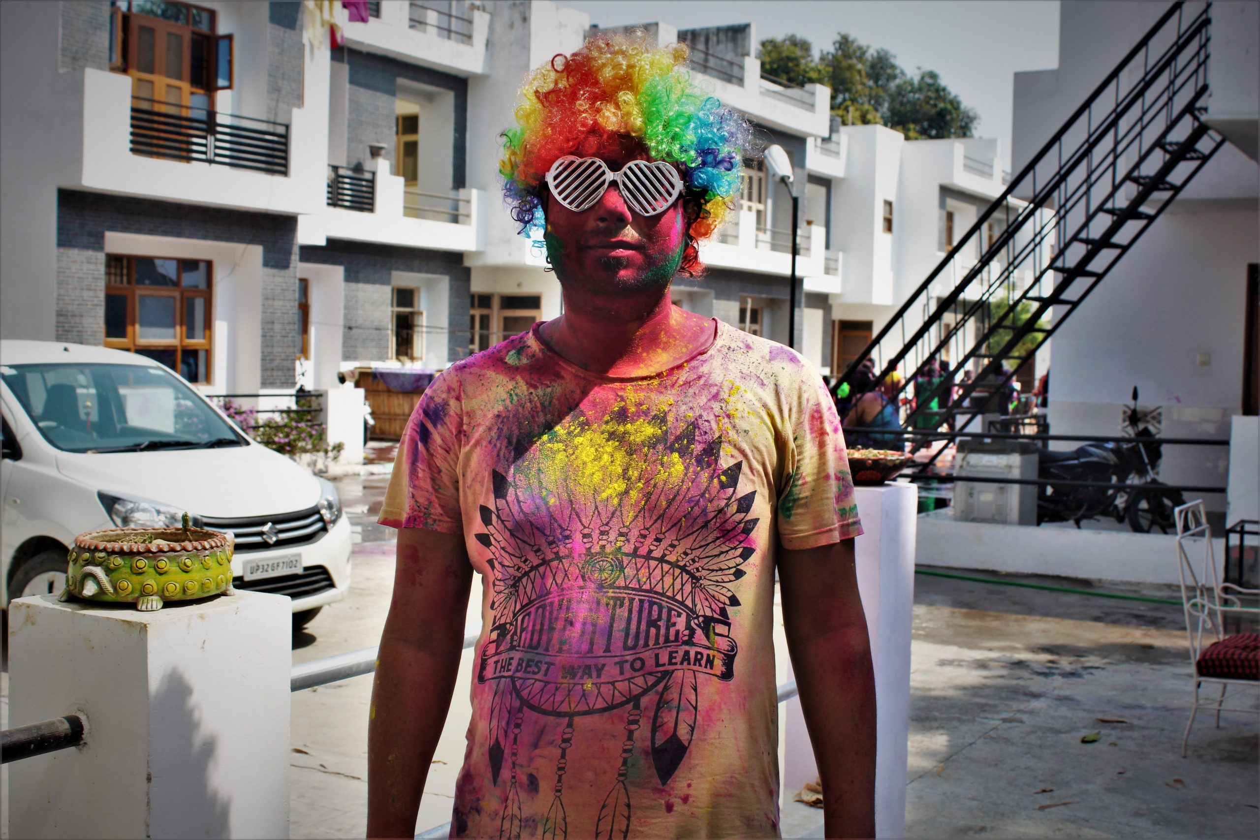 Man posing in society after playing Holi