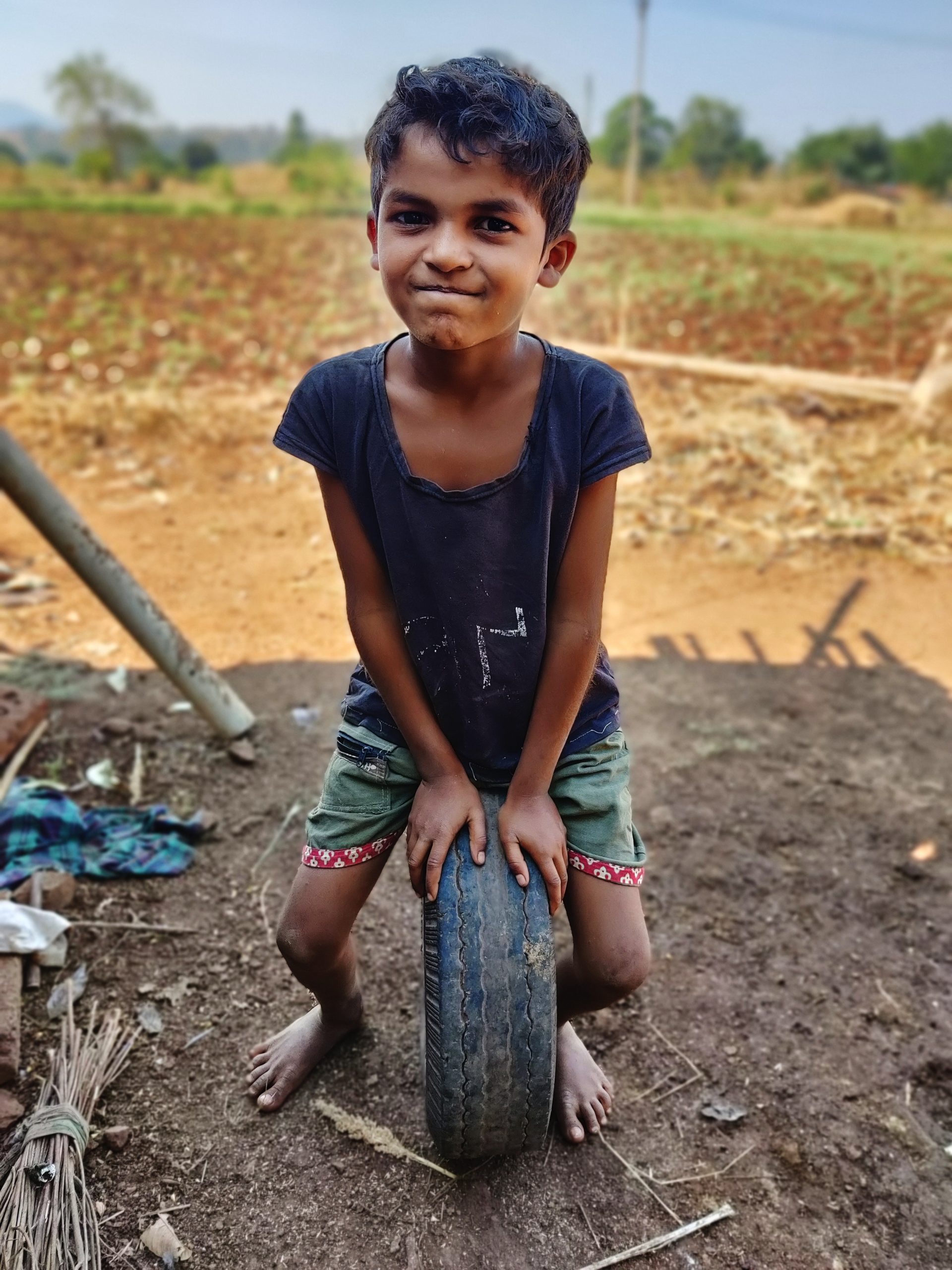 A boy sits on a tyre