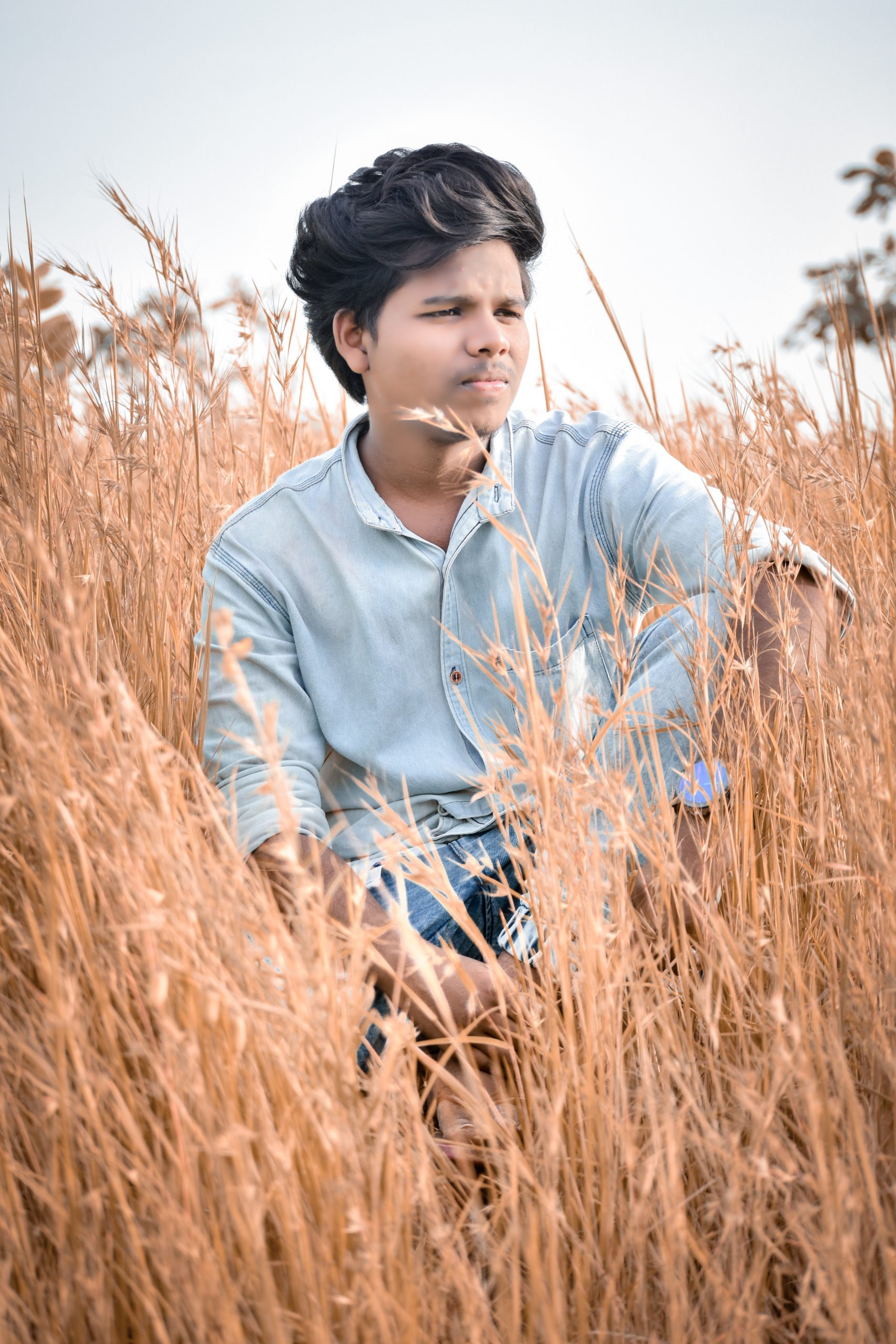 A boy sitting in grass