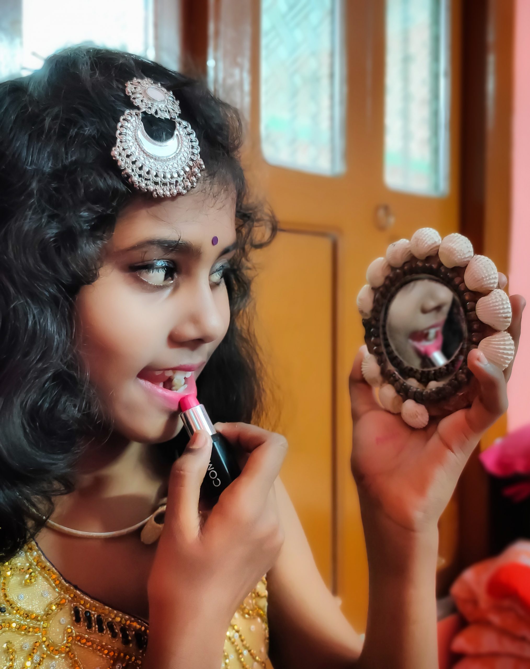 A girl using lipstick