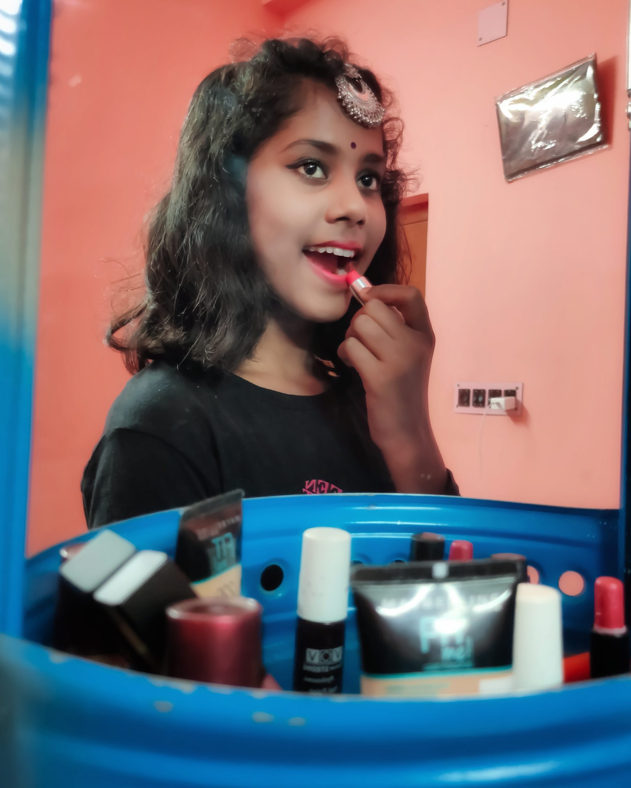 A girl using lipstick