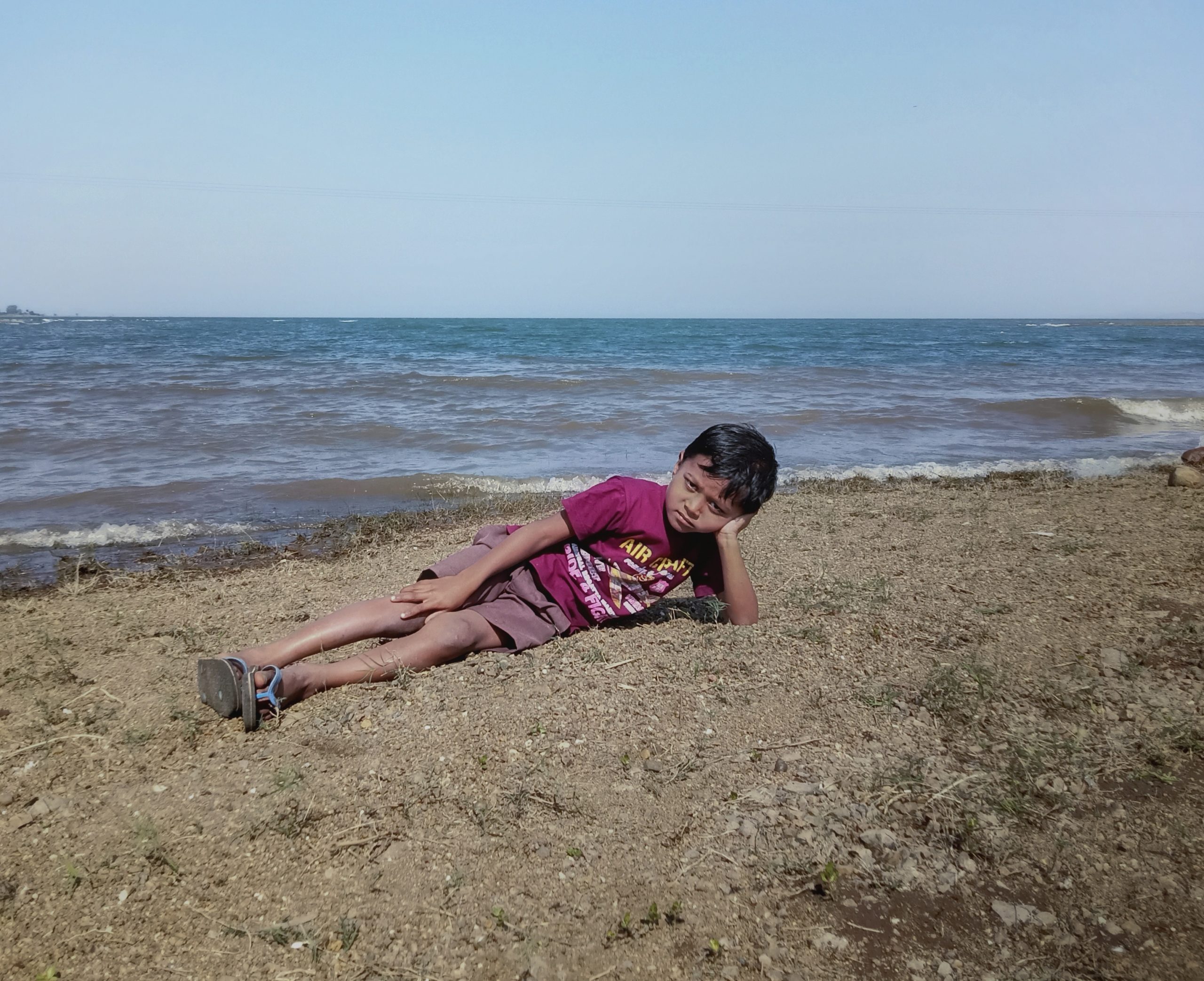 A little boy relaxing on a beach