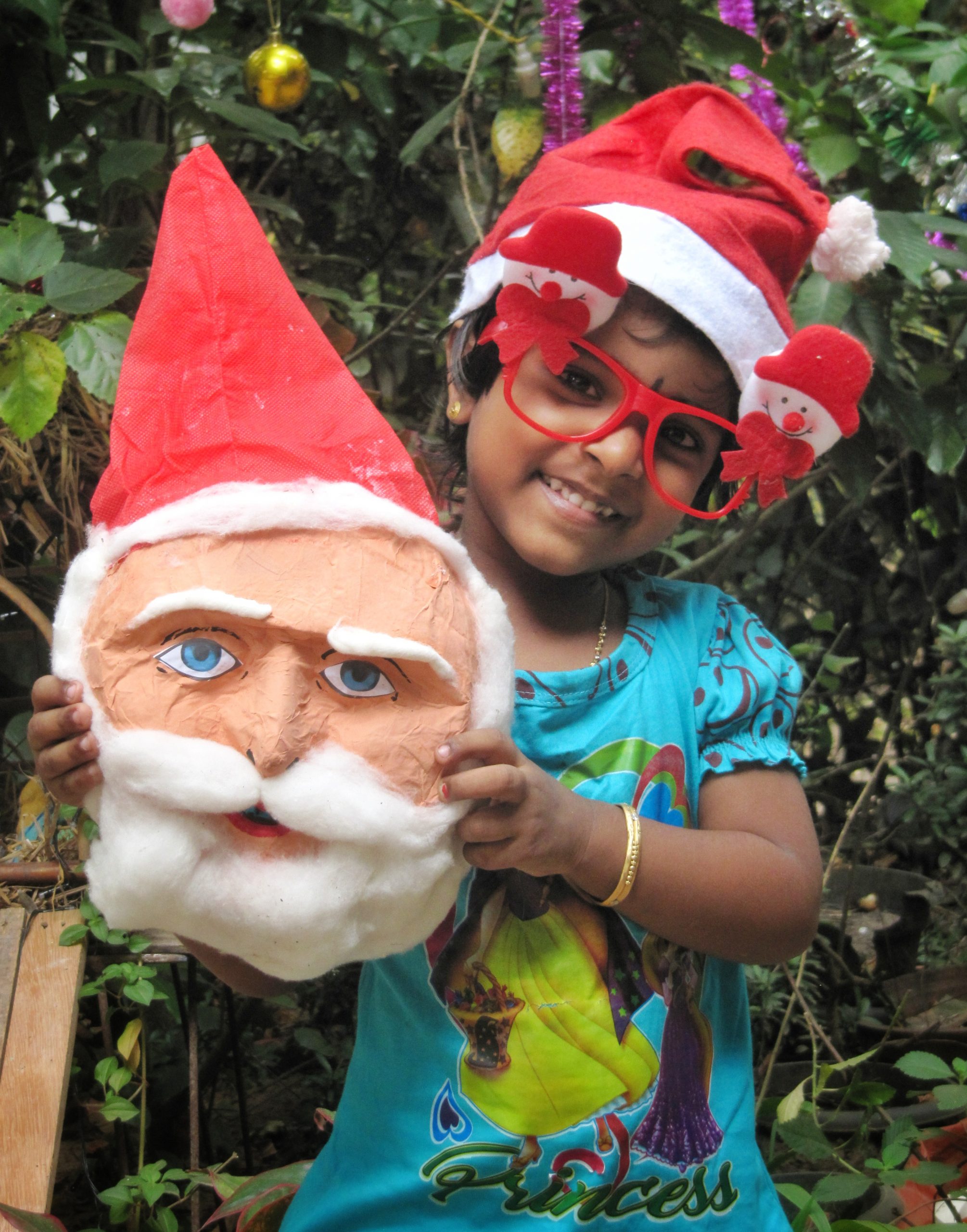 A little girl with Santa Claus mask