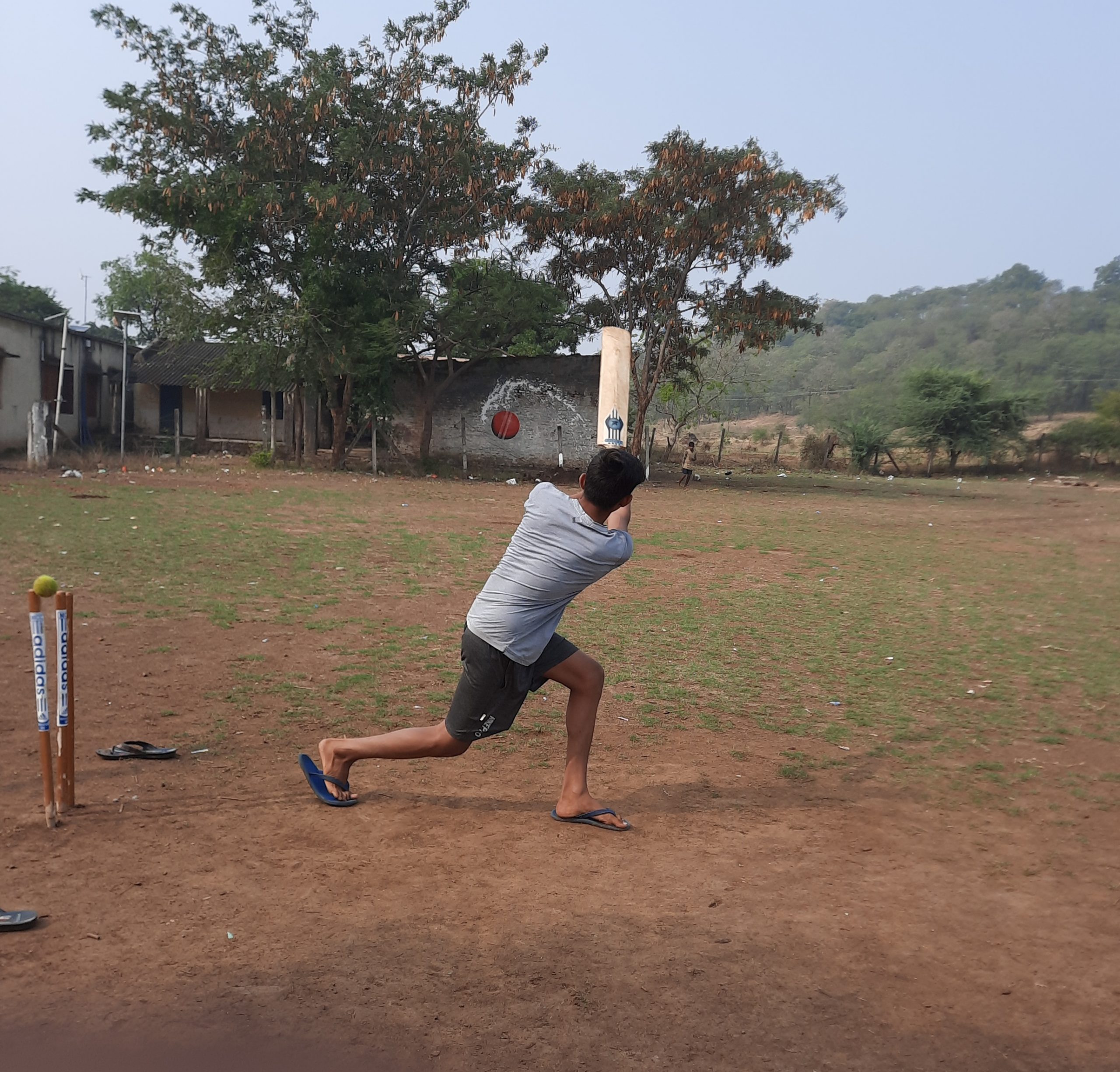 A local boy playing cricket