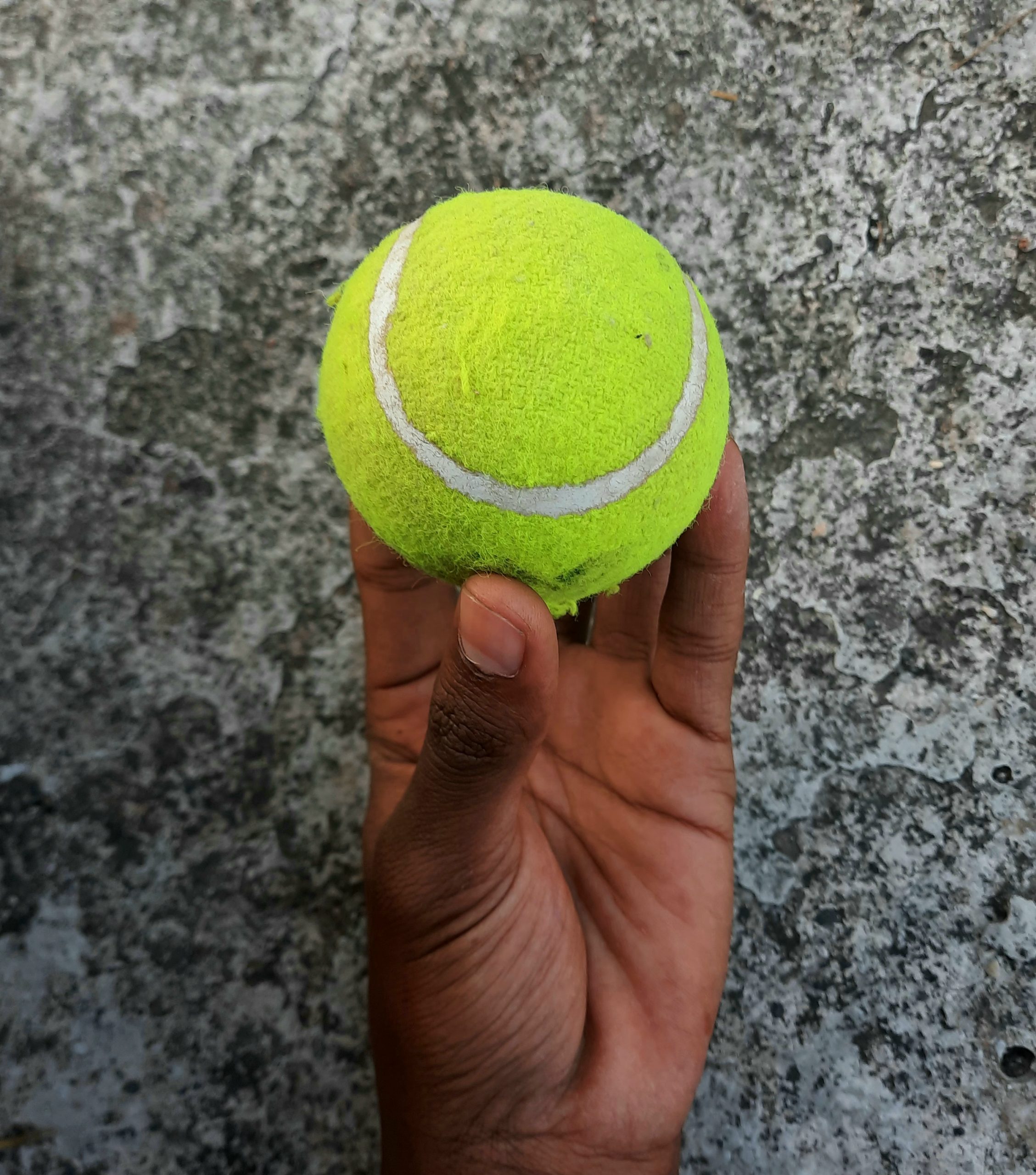tennis ball in hand