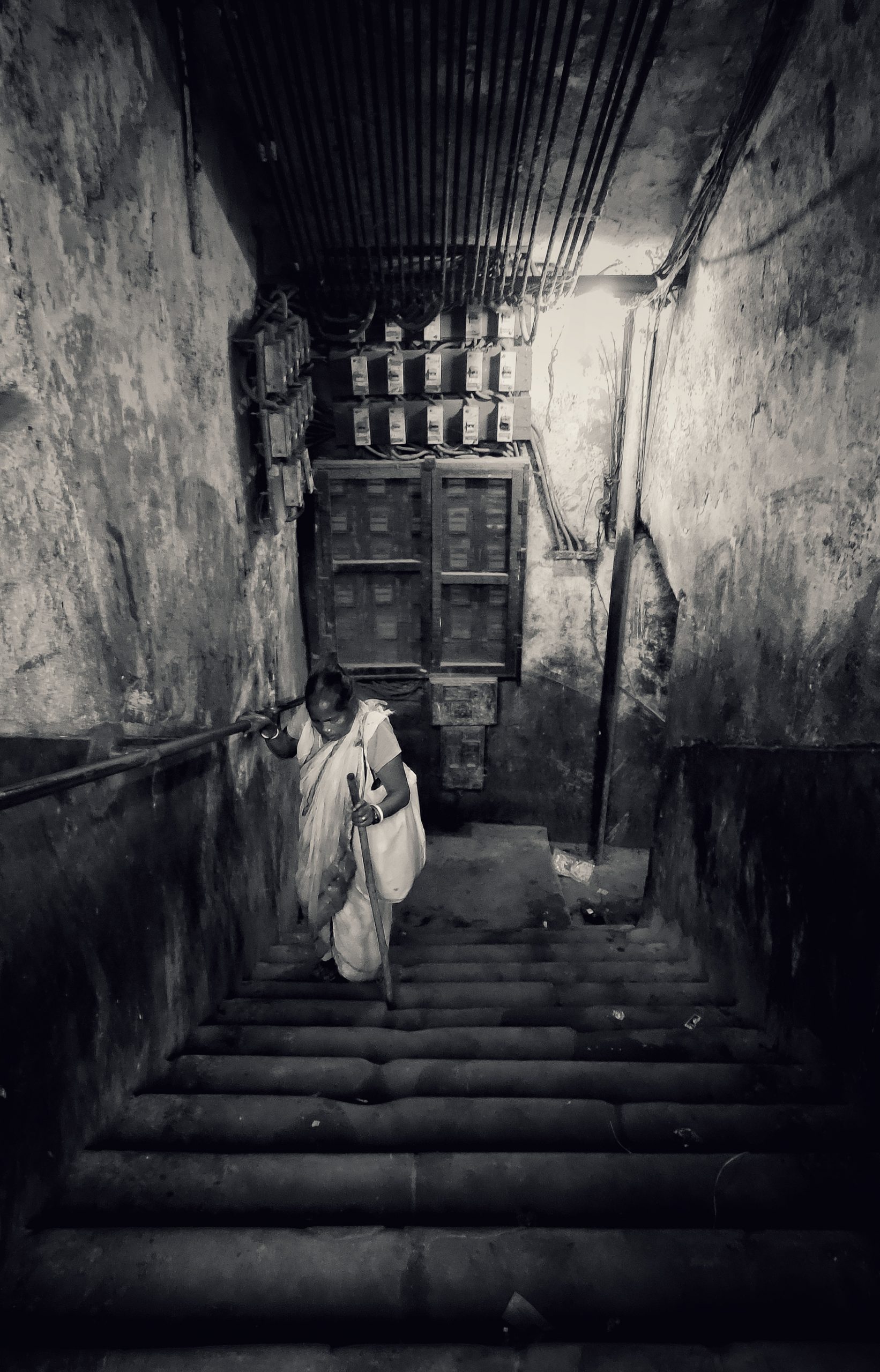 An old woman climbing stairs