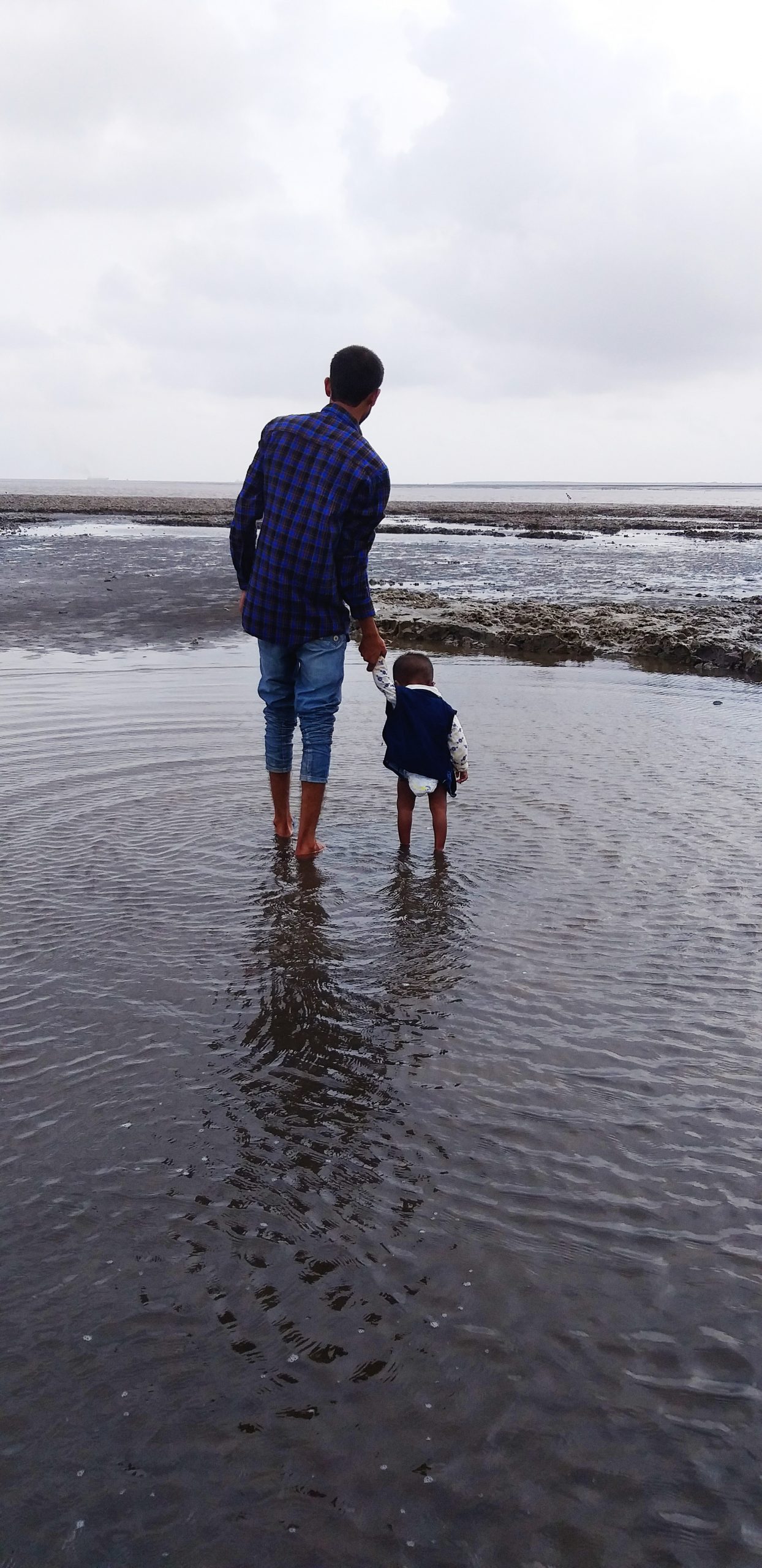 A father and kid on a beach