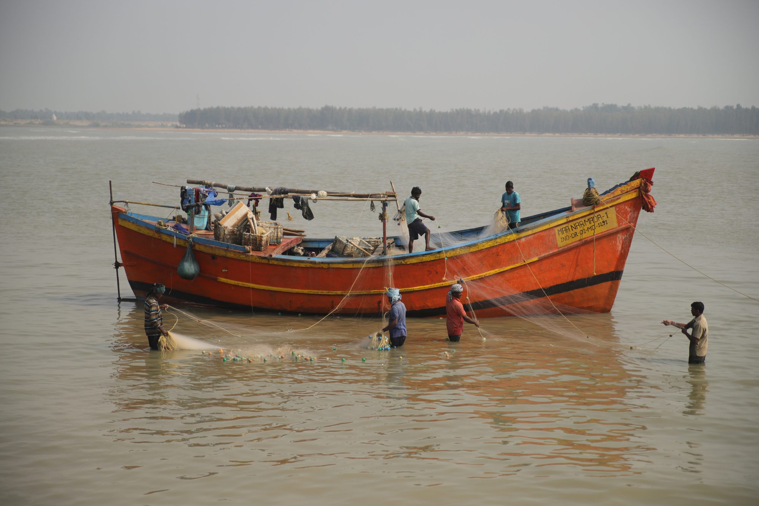 Fishermen and boat in river