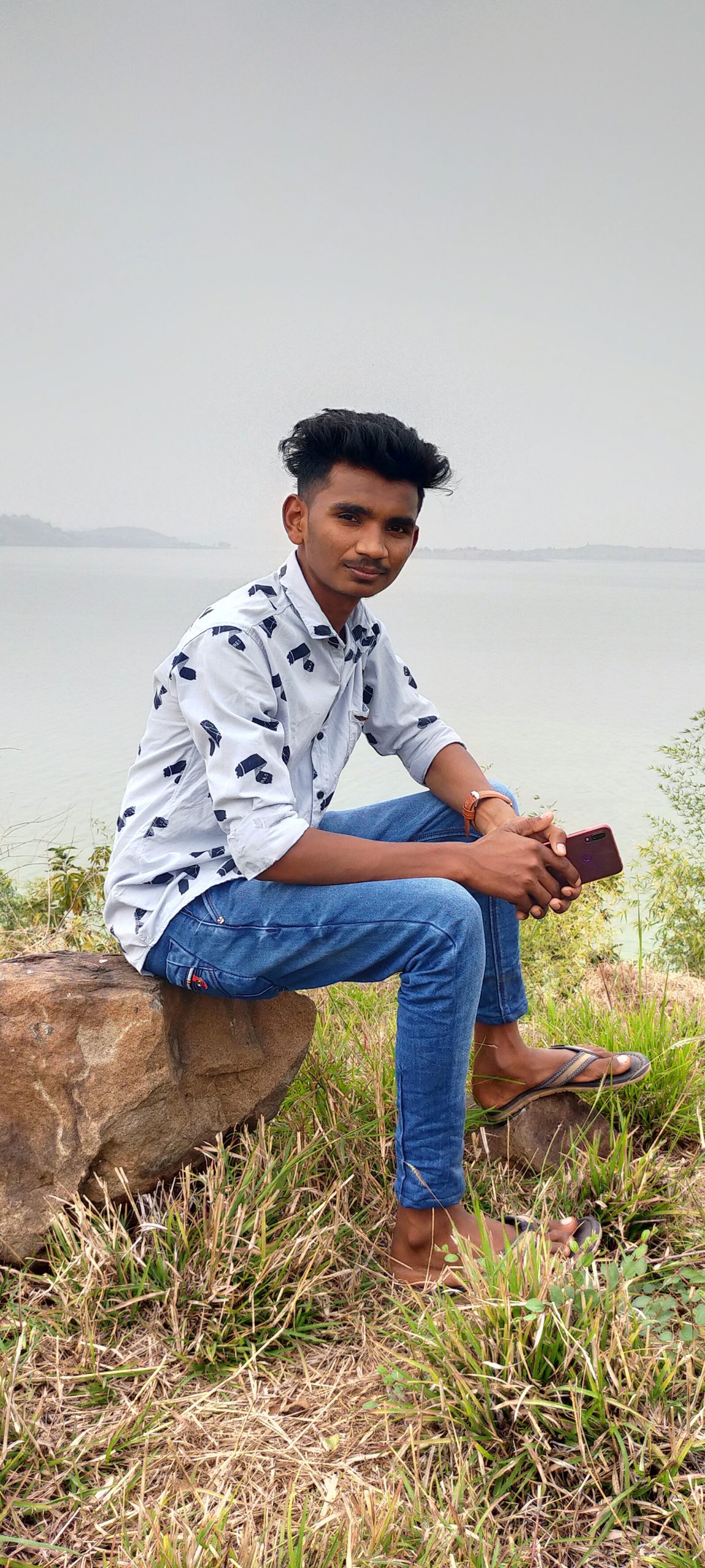 Boy sitting on rock