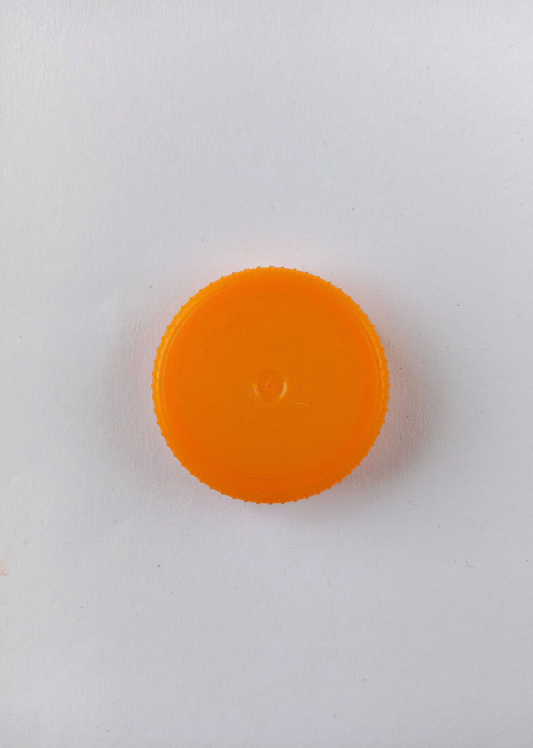 A circular plastic cap