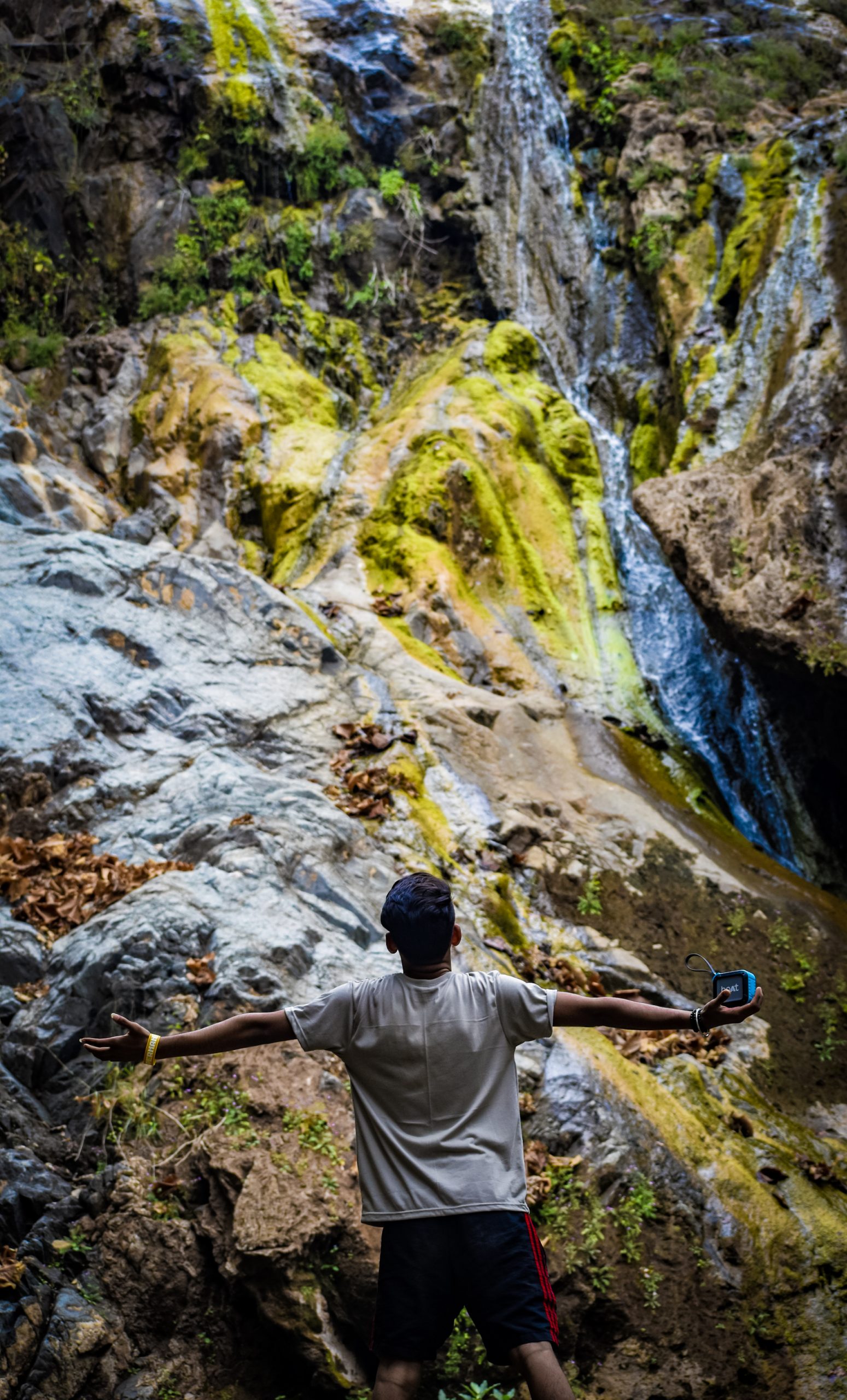A boy near a waterfall