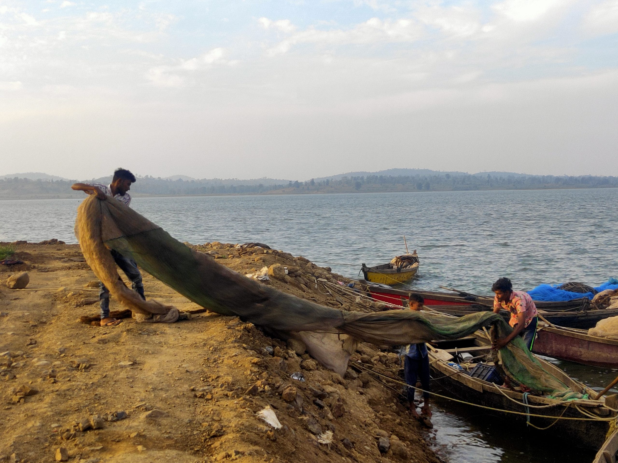 Fishermen arranging fishing net