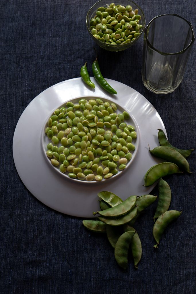Fresh lima beans stacked together on a white plate PixaHive