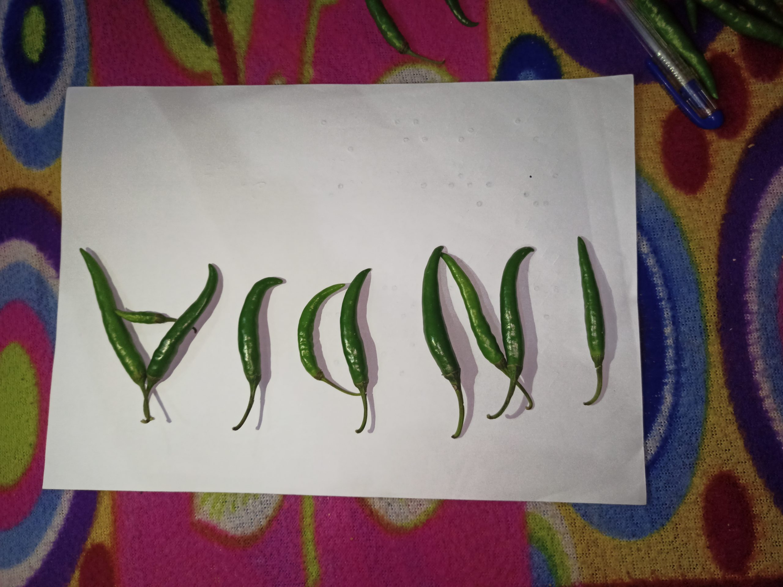 Green chilies on a paper