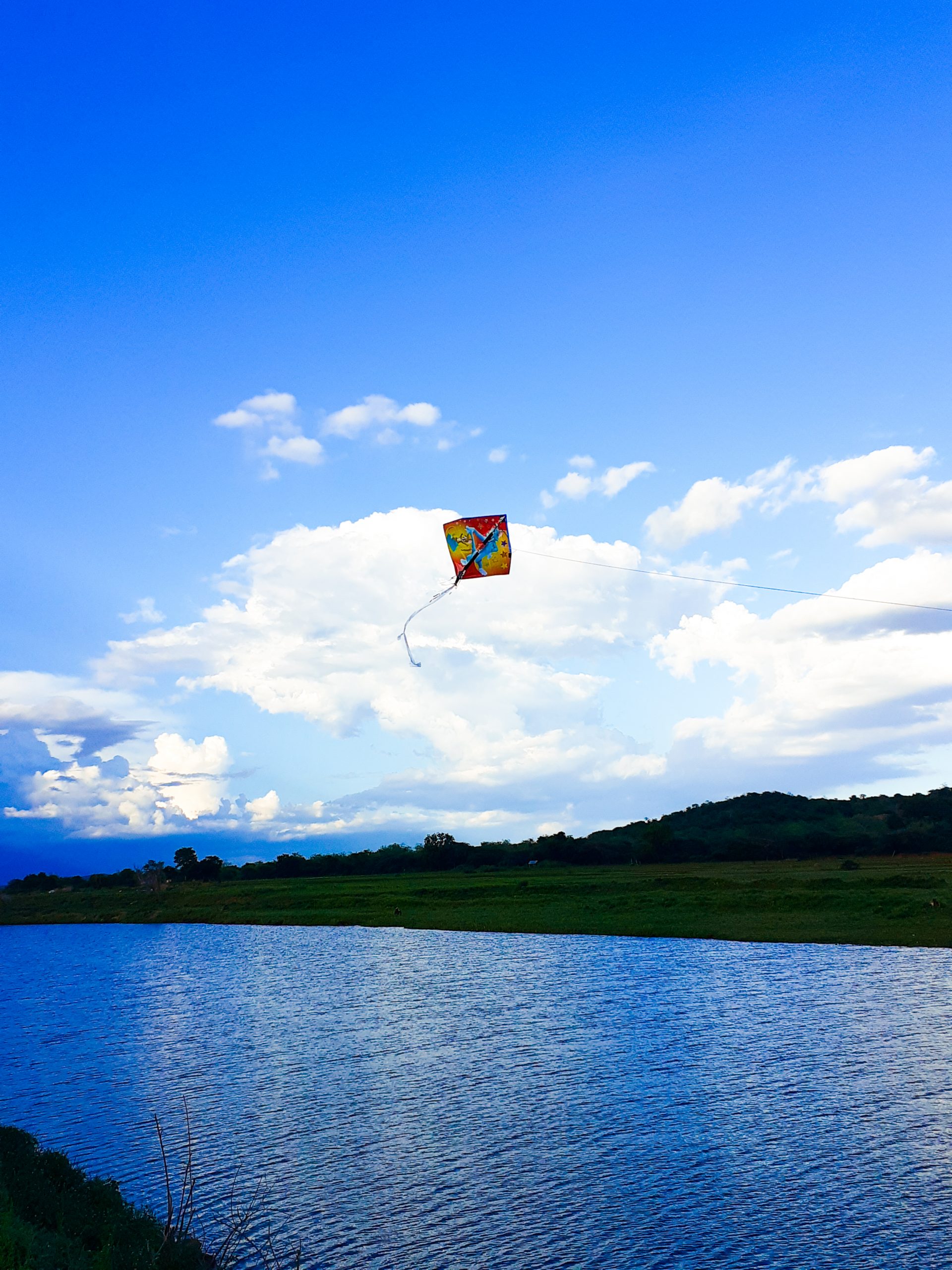 kite flying over a lake