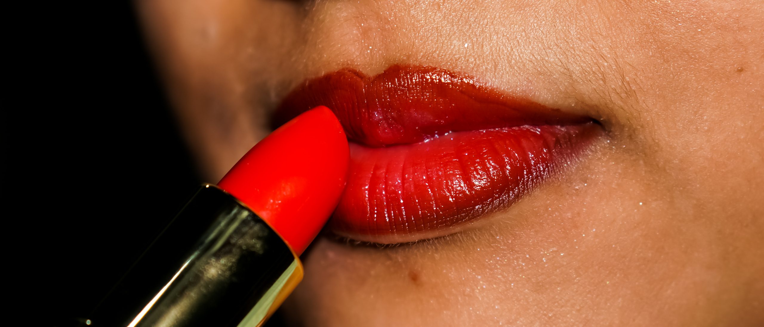 girl applying lipstick