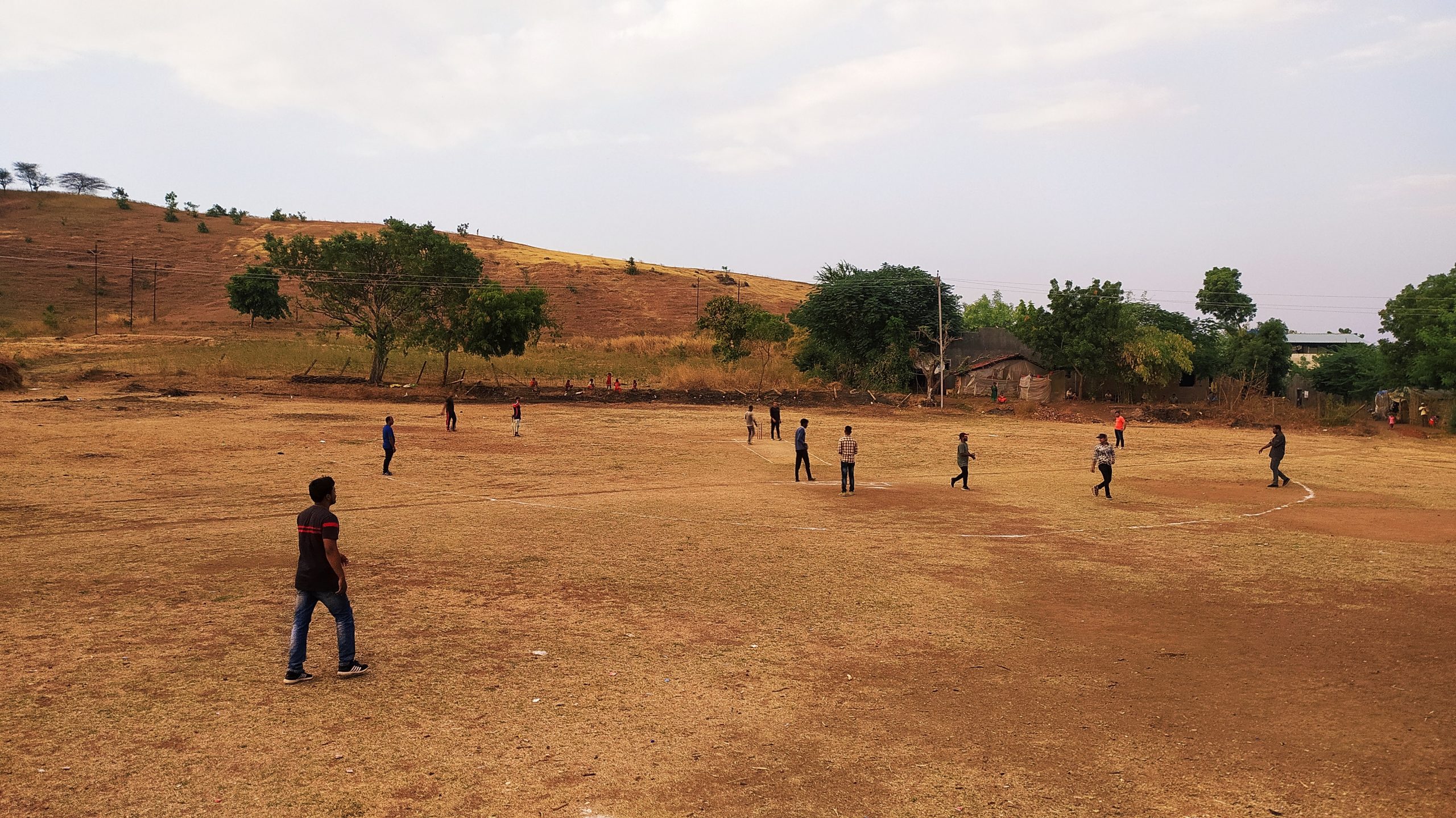 Boys playing cricket in a ground