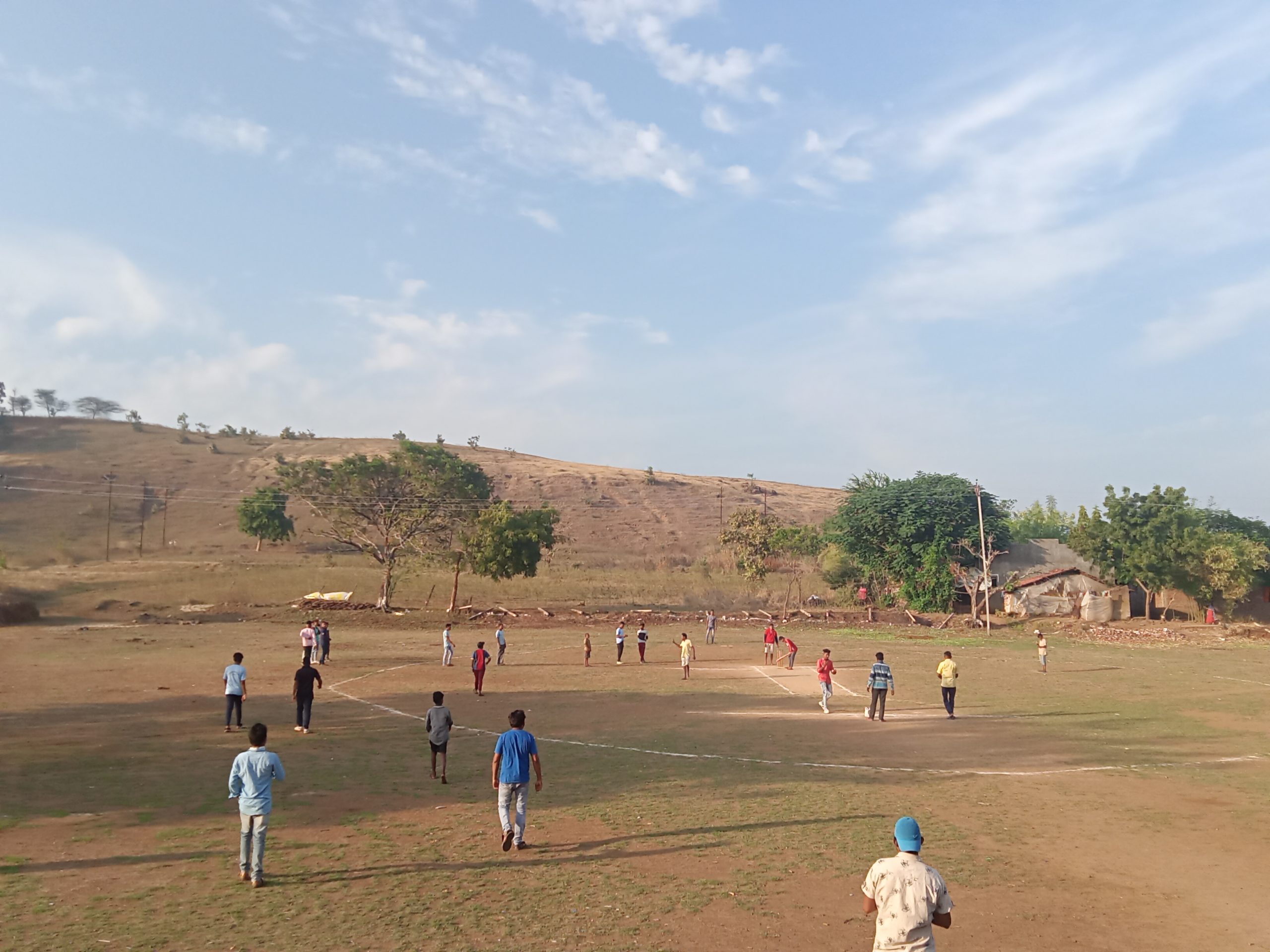 boys playing cricket in a ground