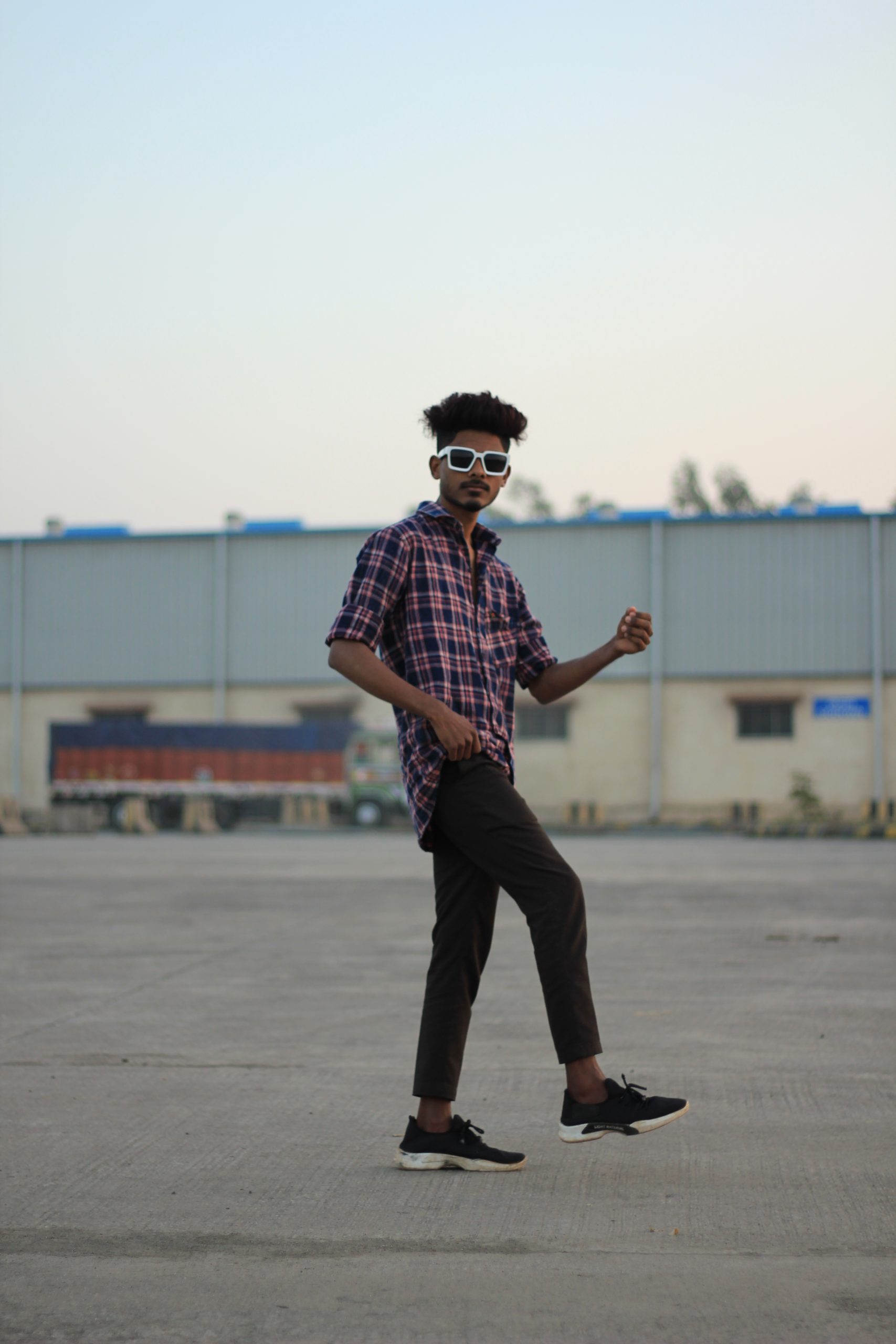 Boy posing outside factory