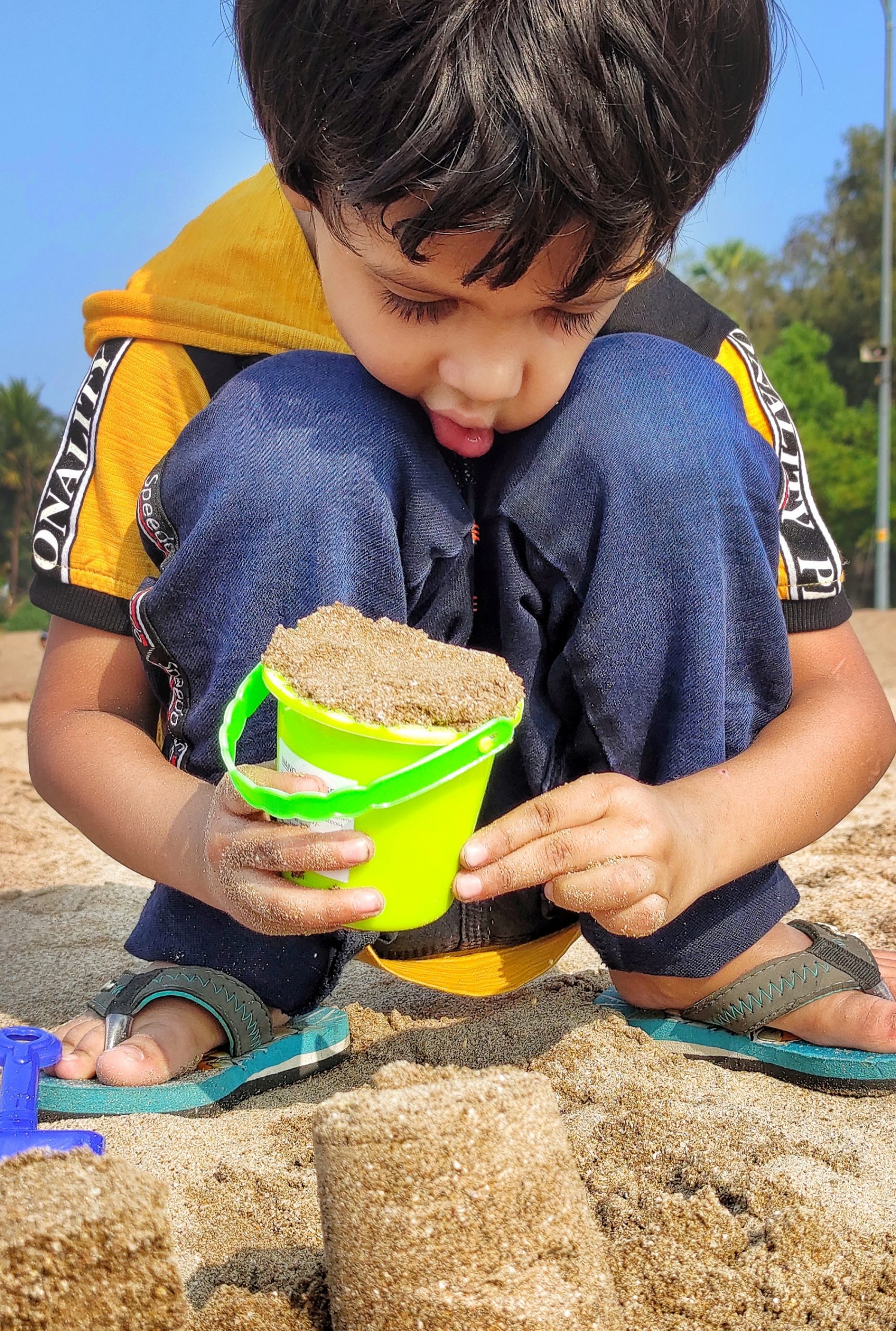 A kid playing with sand