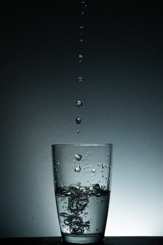 Water drops into a half glass of water in it - PixaHive