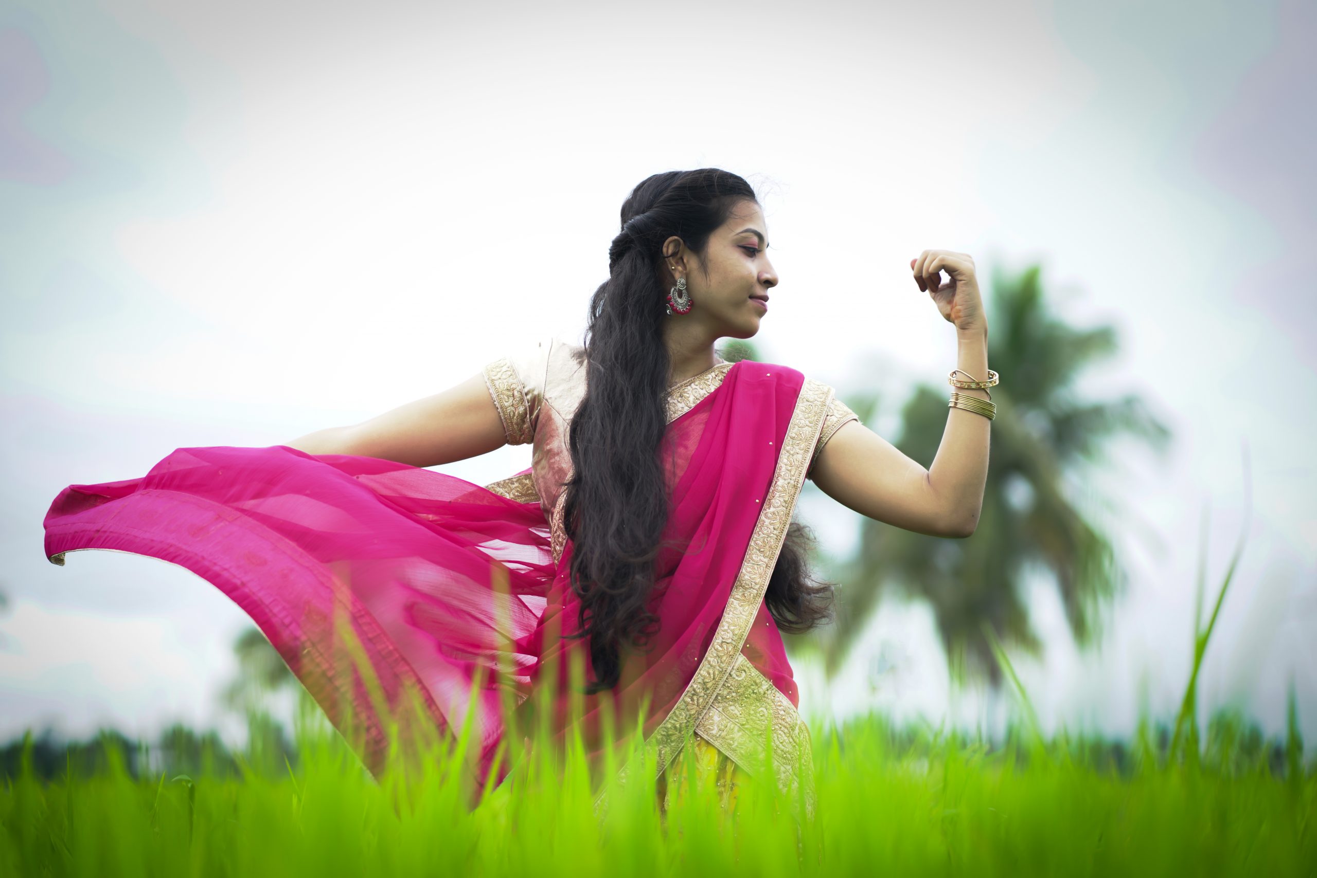 A Indian girl dancing in fields