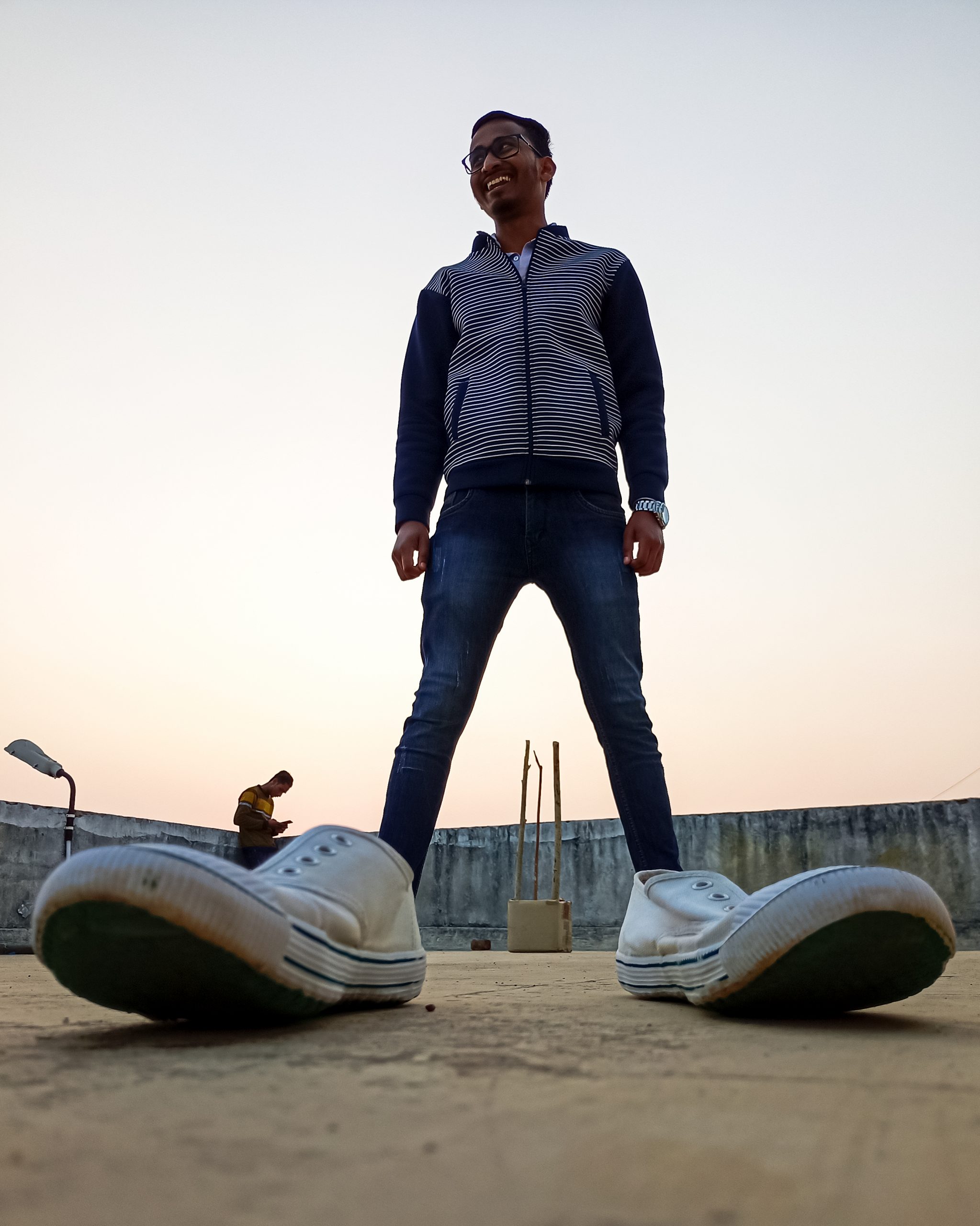 Boy posing with shoes on roof