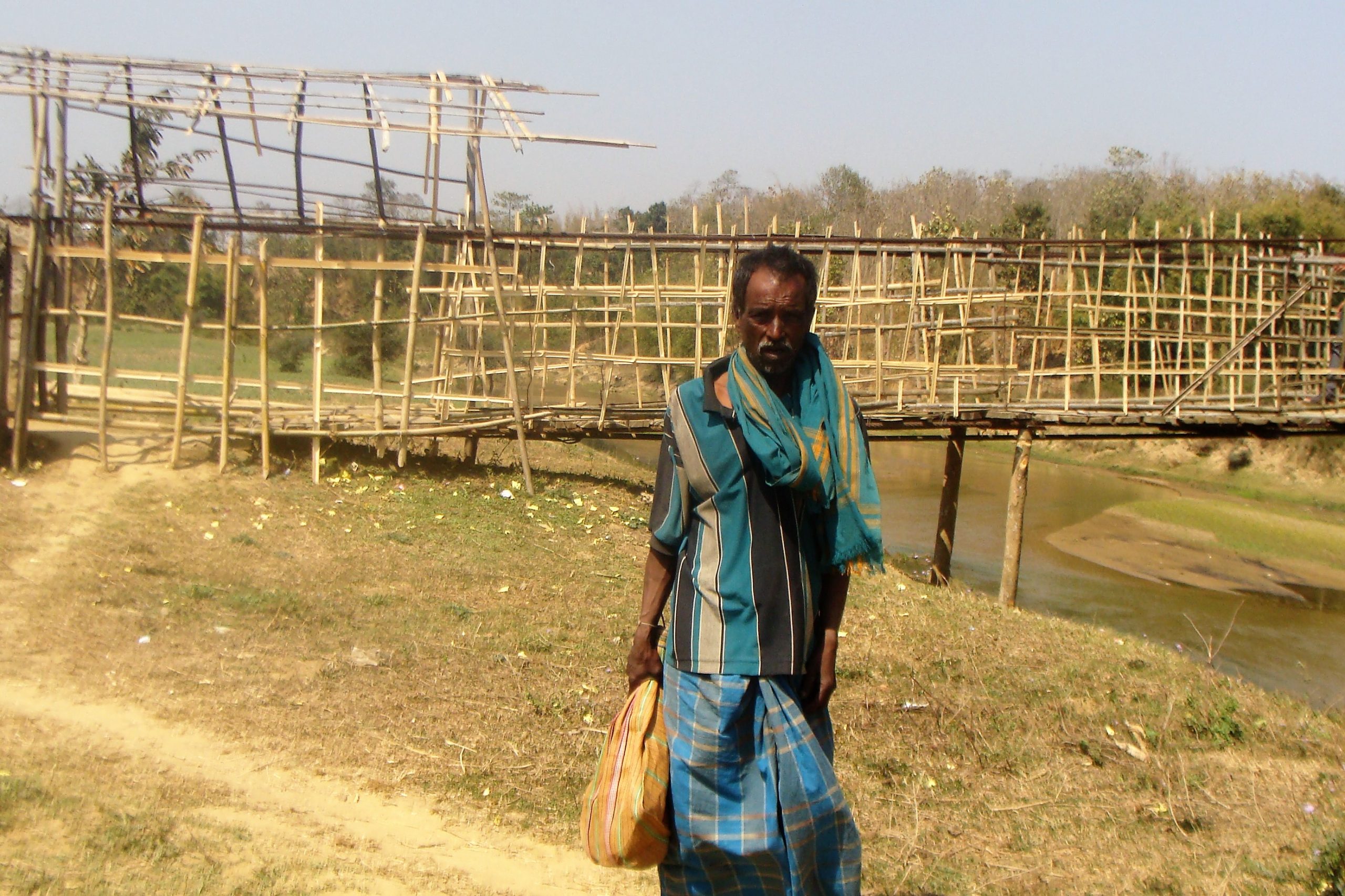 A village man near a bamboo bridge