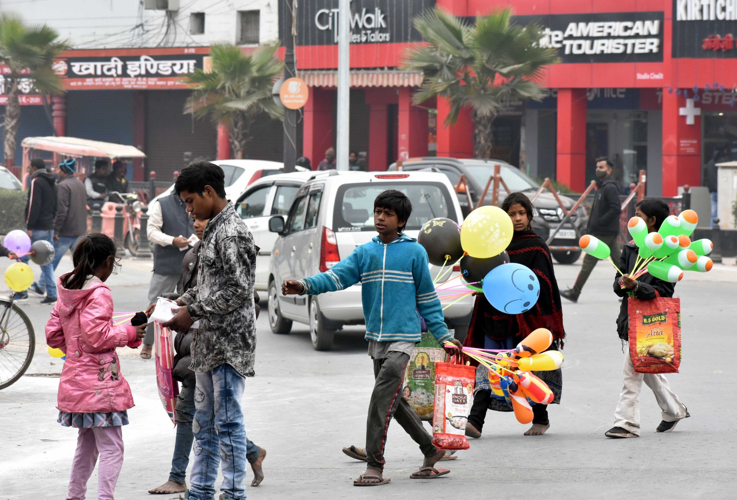 Kids selling balloons on road