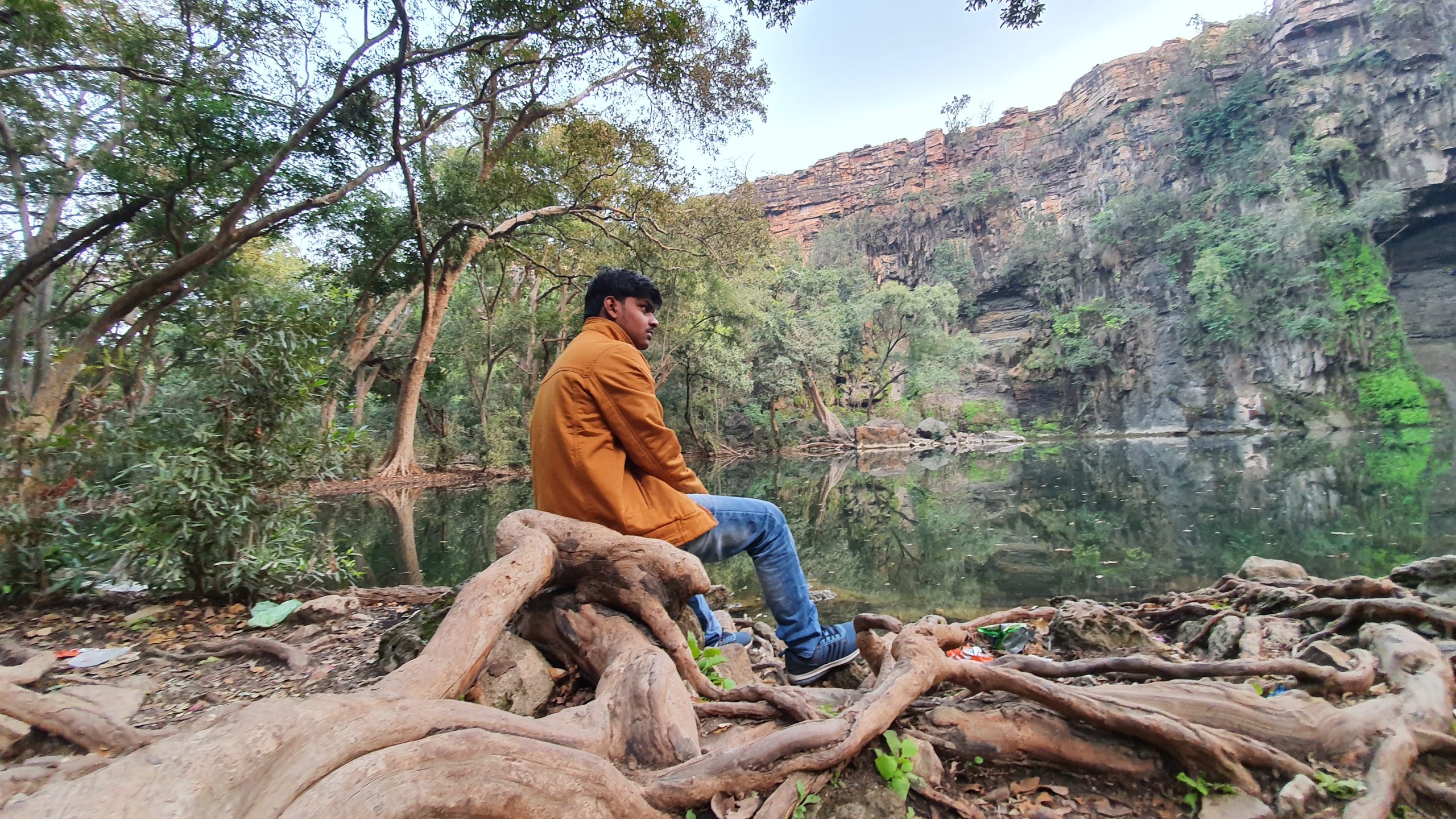 Boy sitting on logs