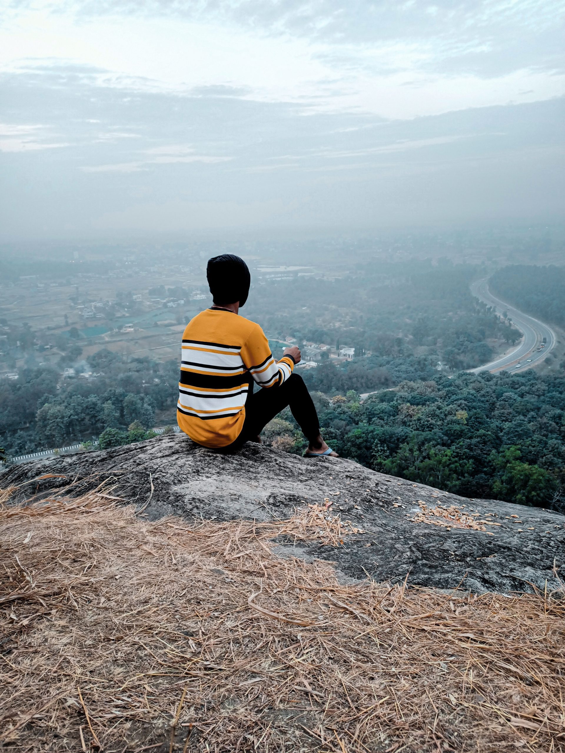 Boy sitting on rock in mountain PixaHive