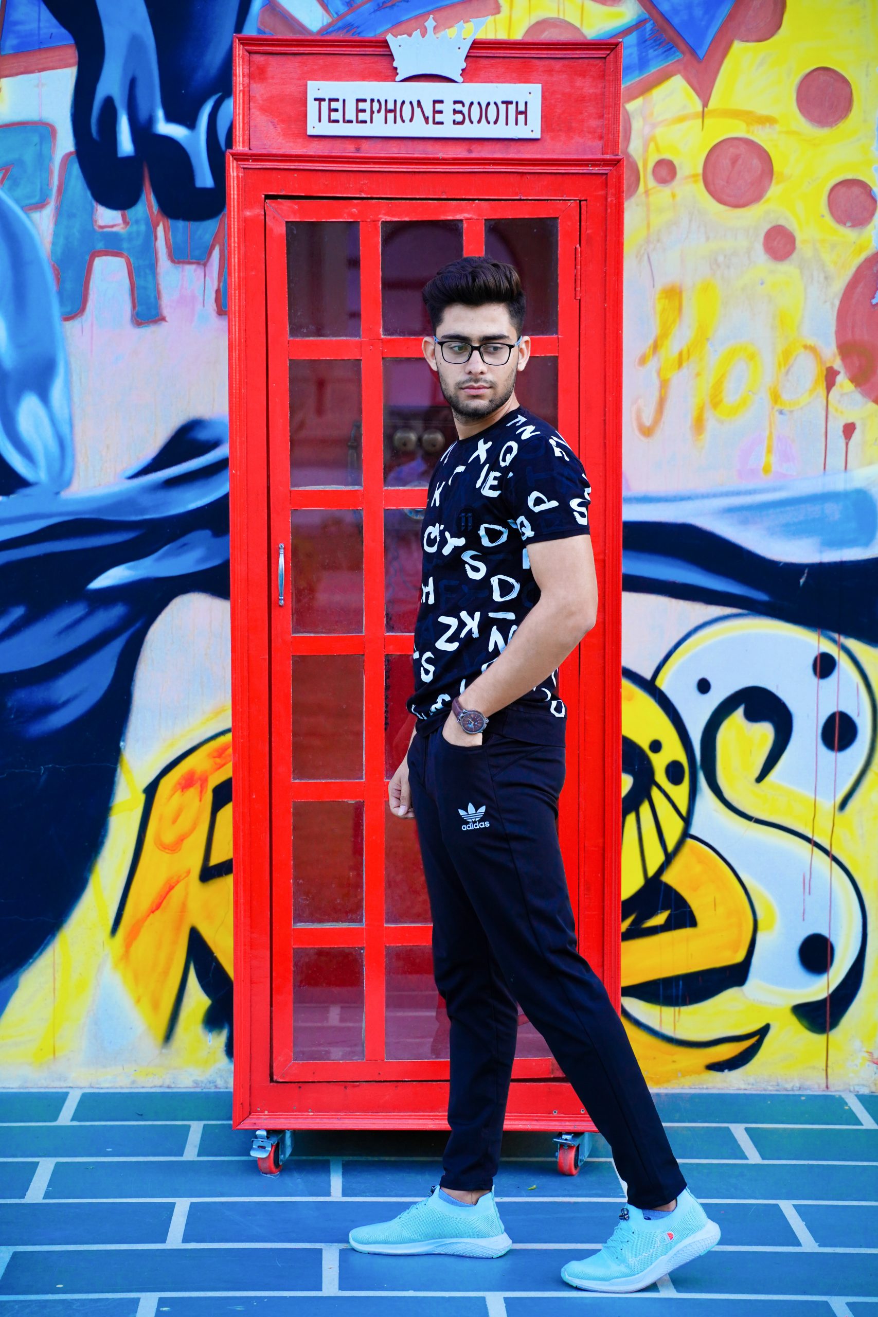 Boy posing in front of telephone booth