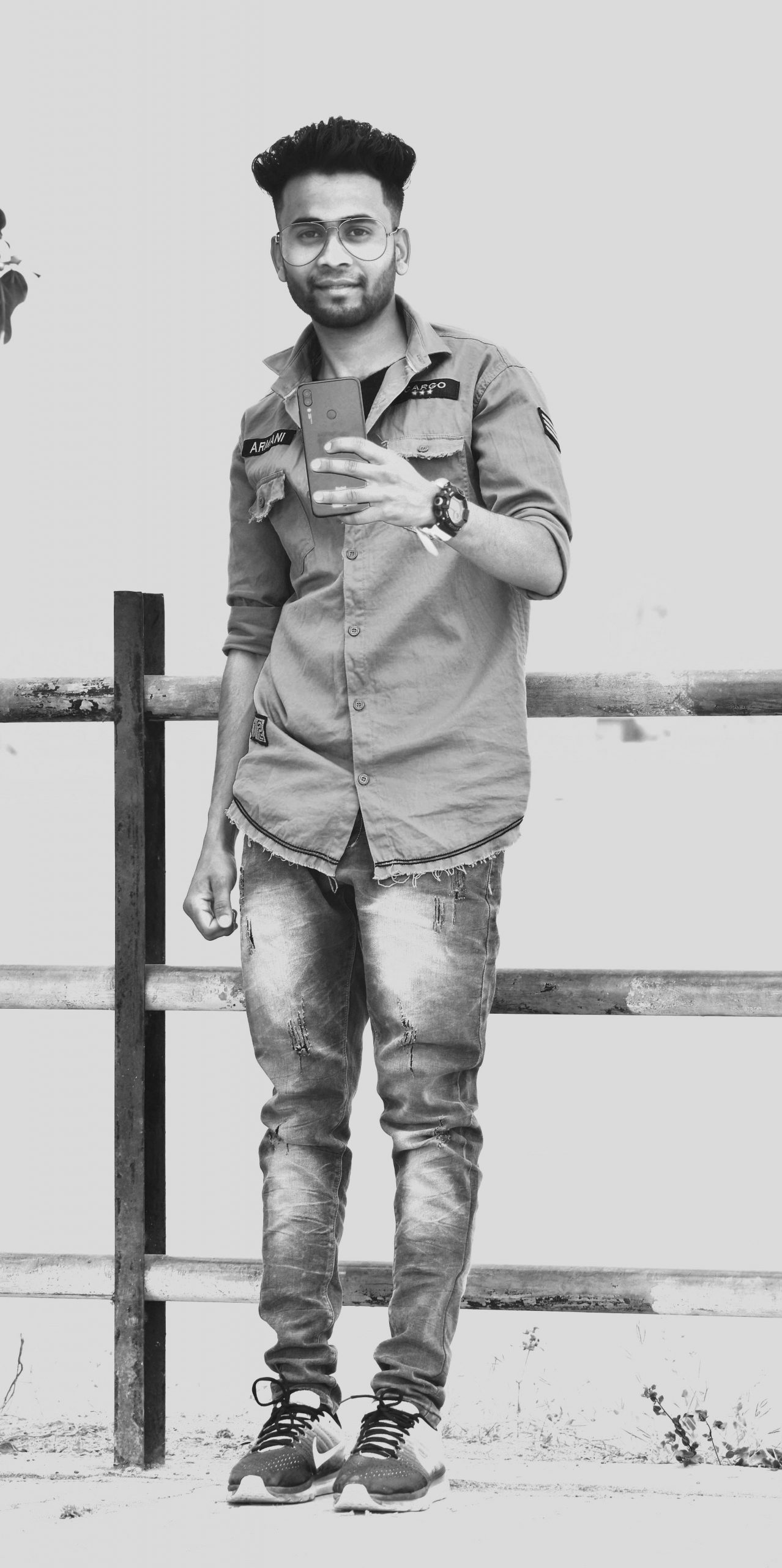 Boy posing on bridge with phone