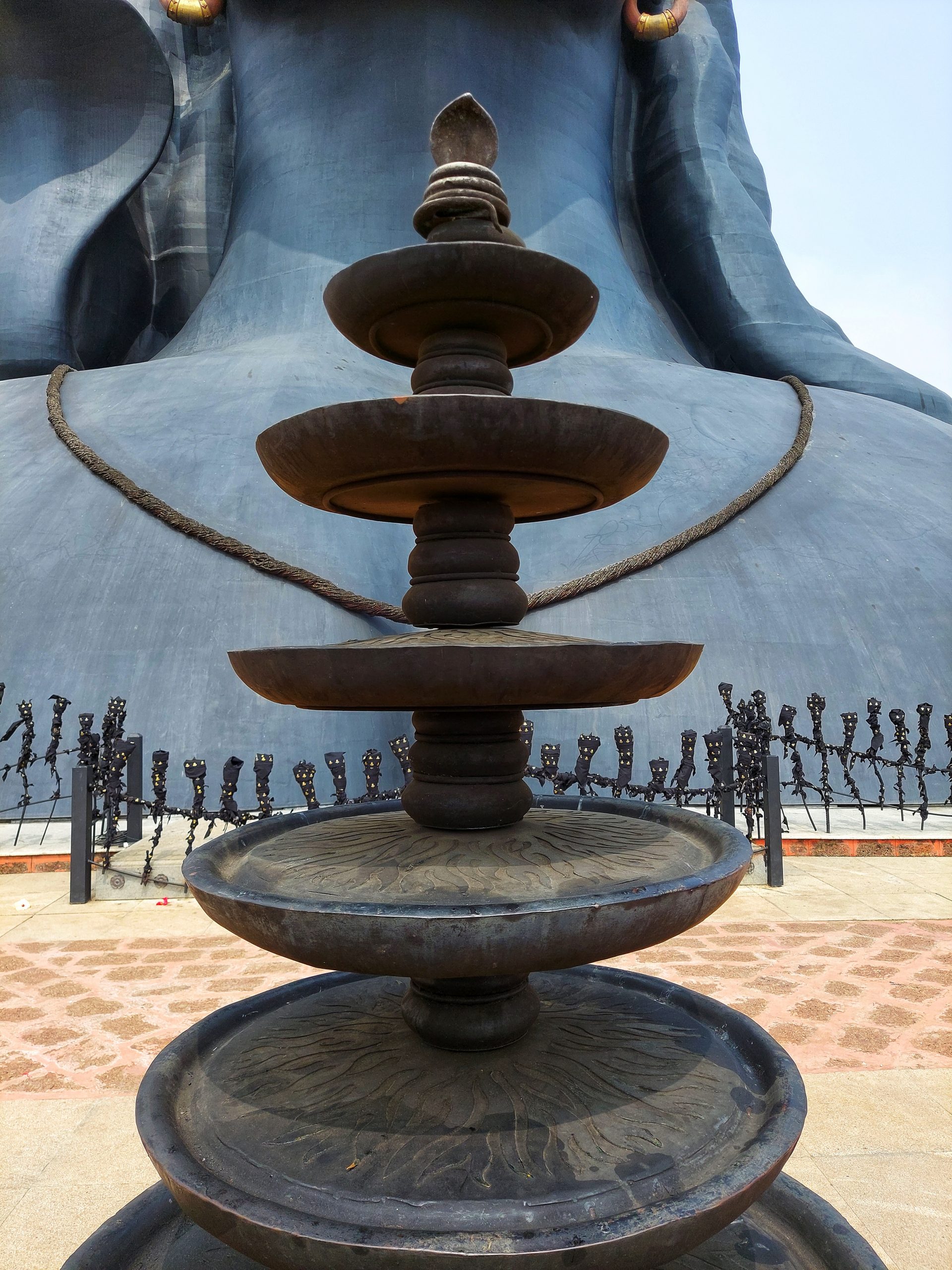 Iron lamp in front of Lord Shiva statue