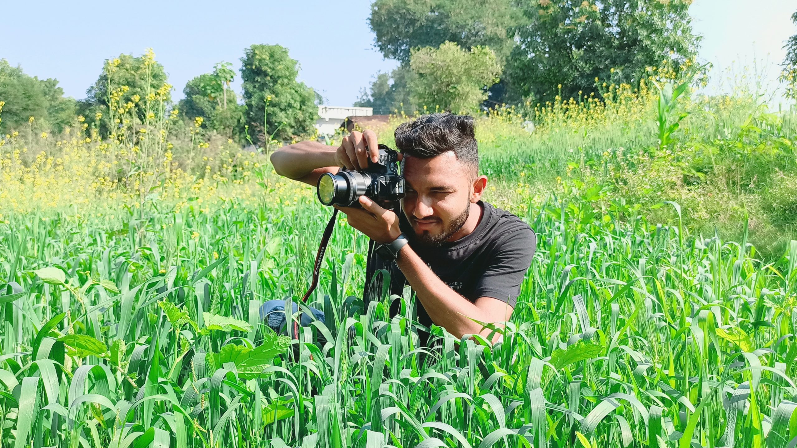 Man clicking picture in crop farm