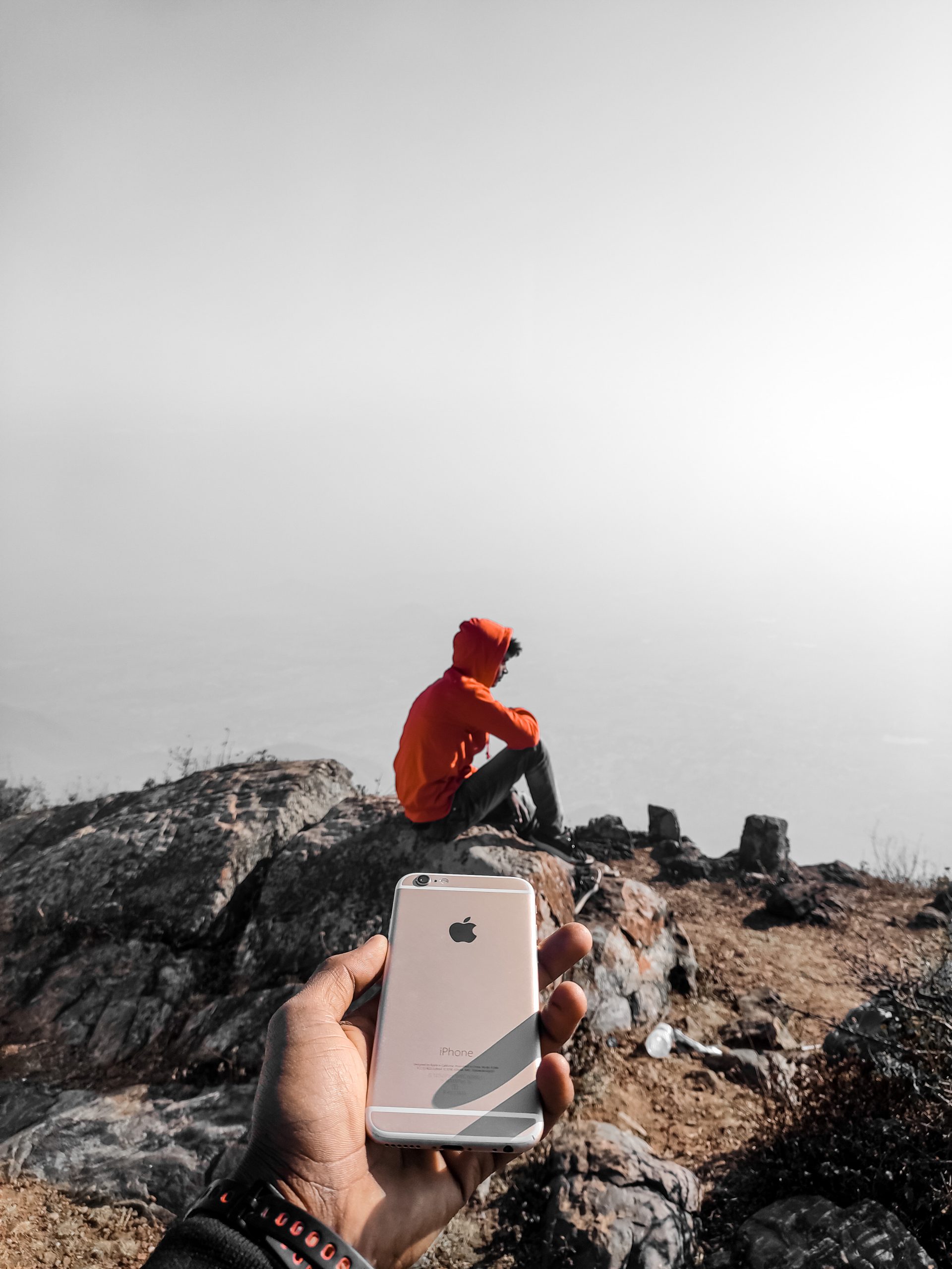 Pointing phone to a boy on hills