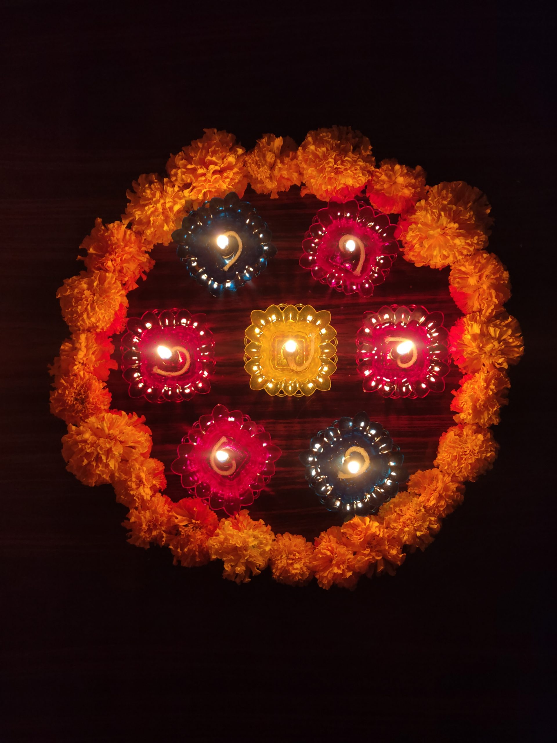 A design make with flowers and oil lamps