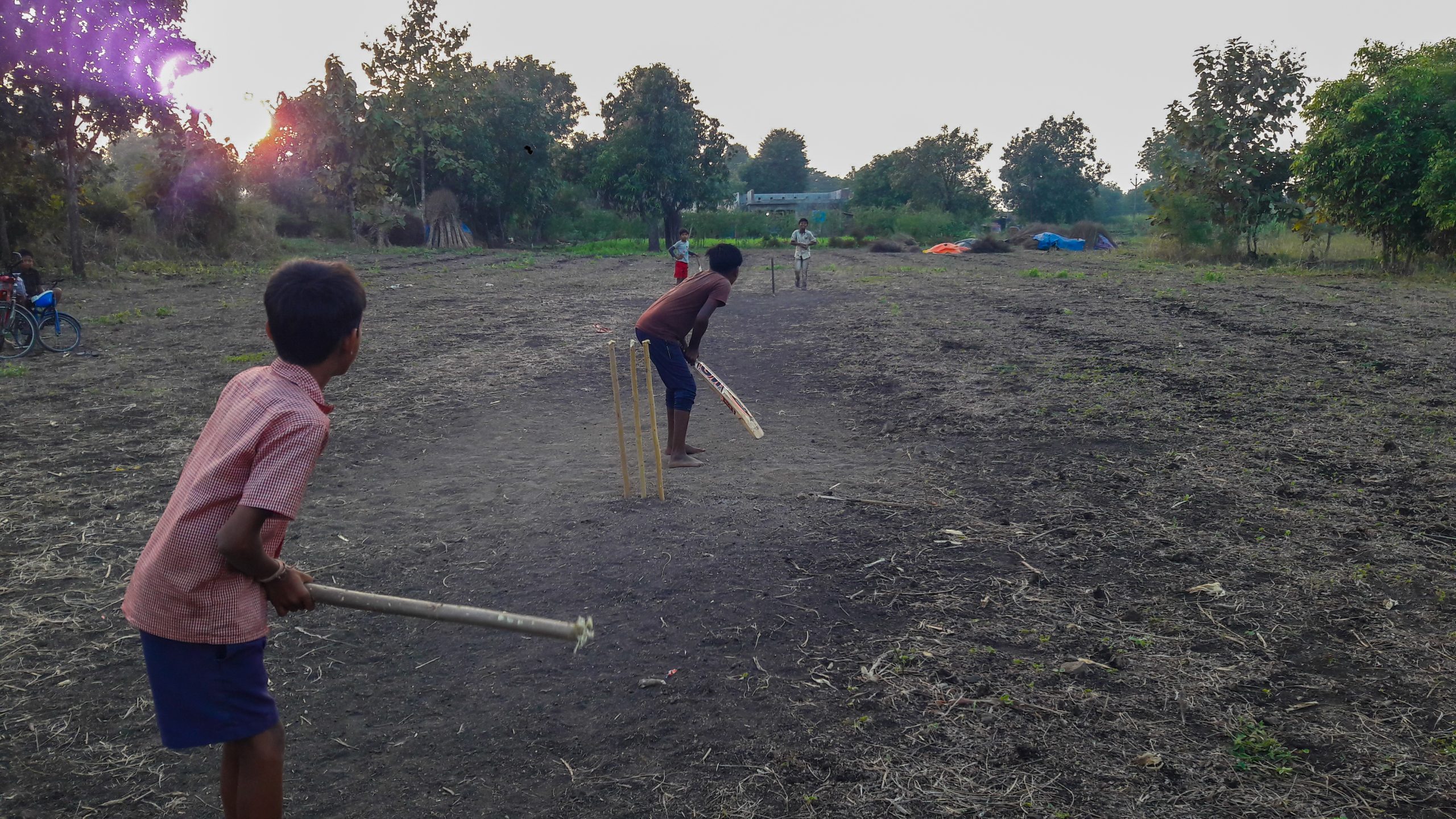 Kids playing cricket in the farm
