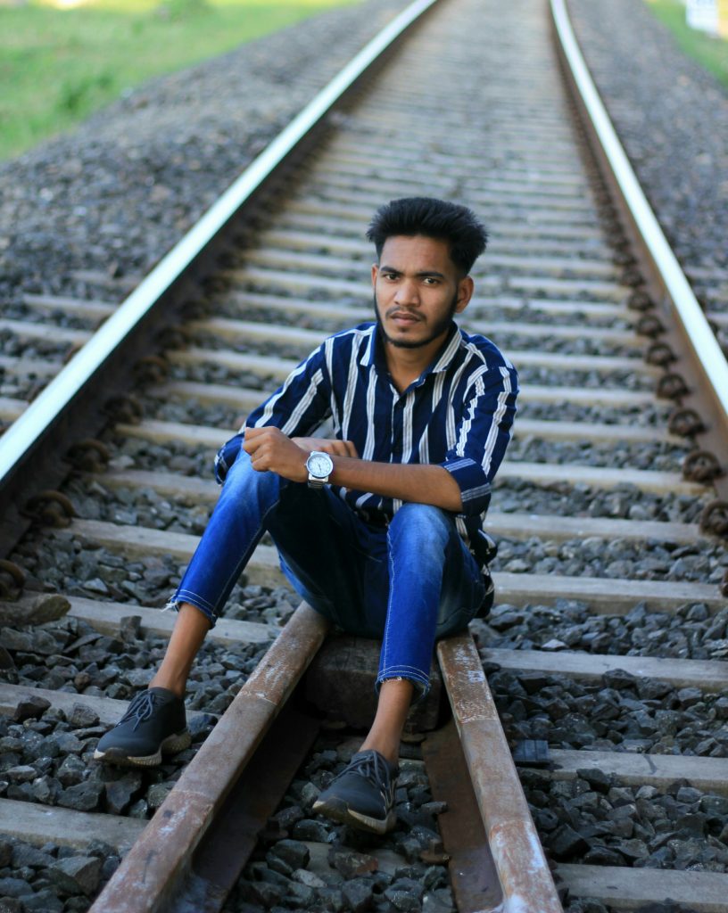 Man sits on train tracks at daytime photo – Free Cherlapalli Image on  Unsplash